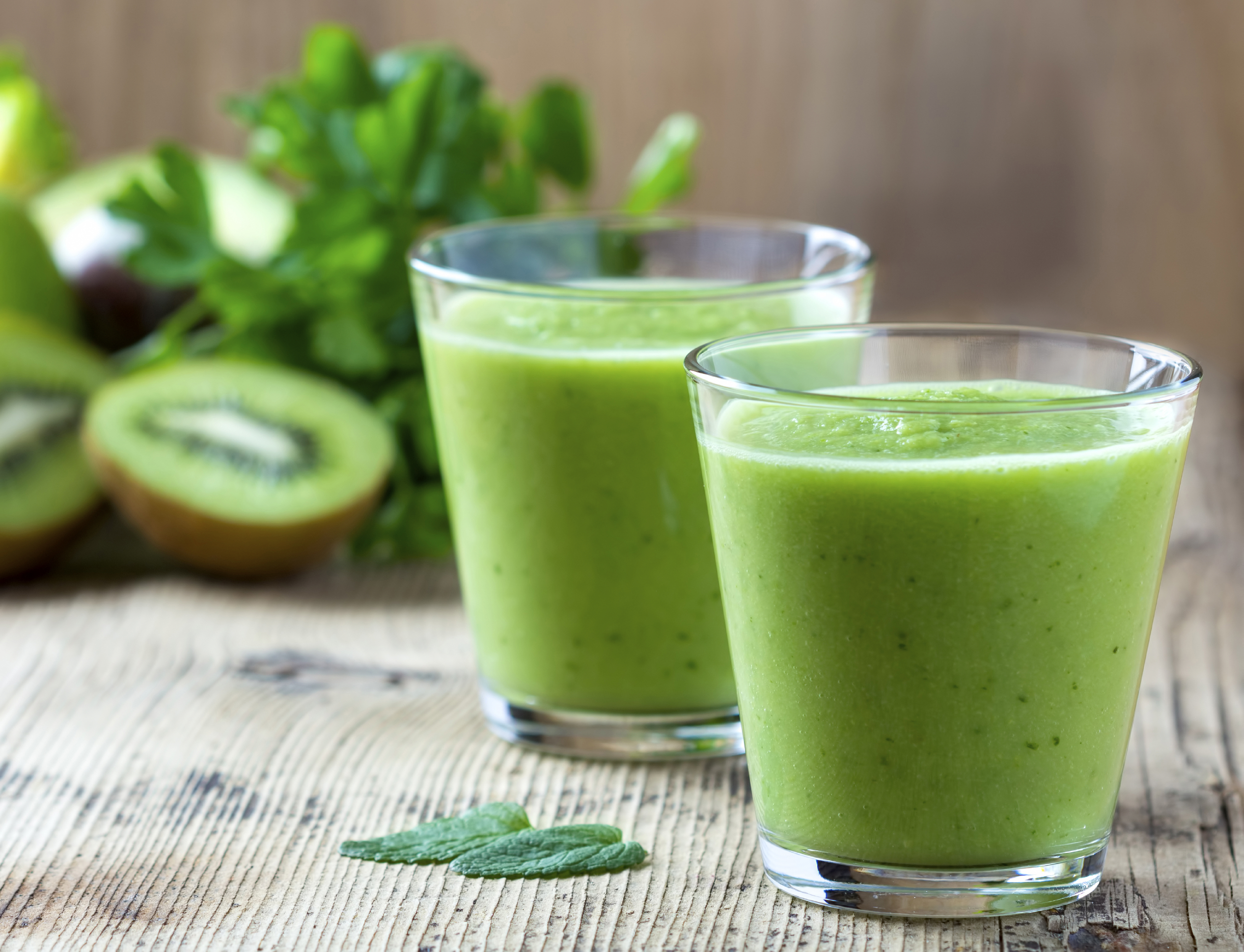 Healthy green Smoothie on wooden table