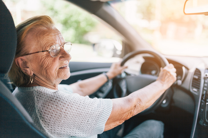 Elderly woman behind the steering wheel