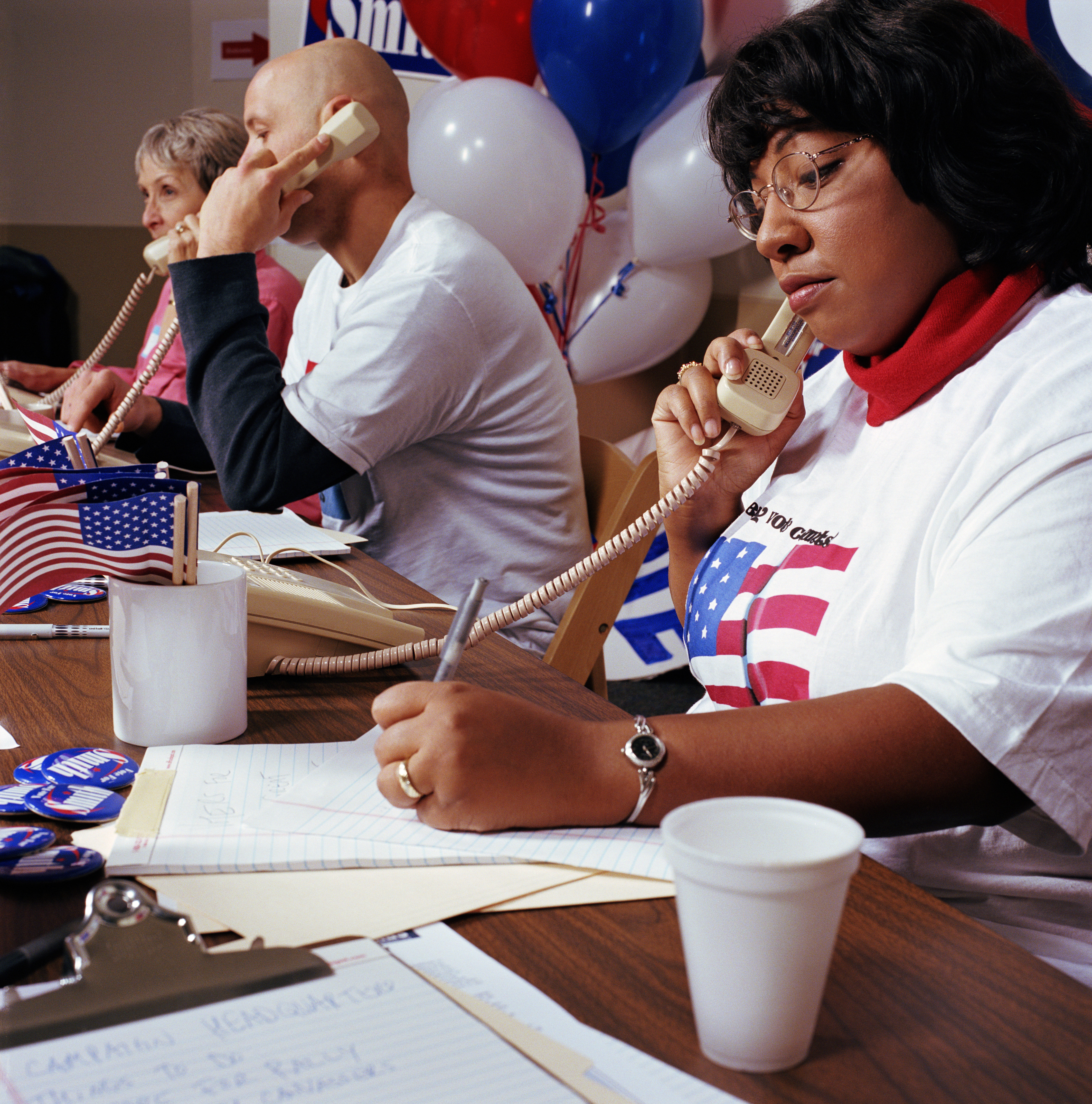 Woman in row of campaign supporters on telephones