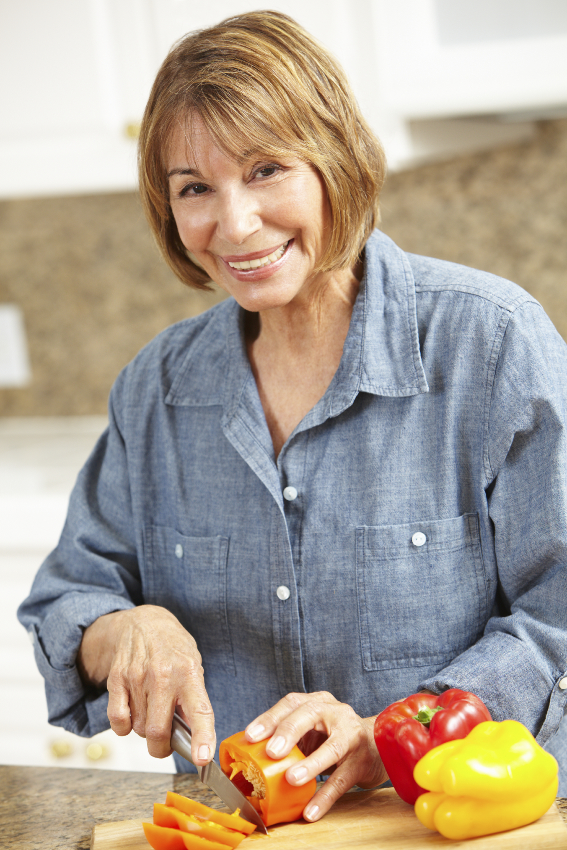 Mid age woman chopping vegetables