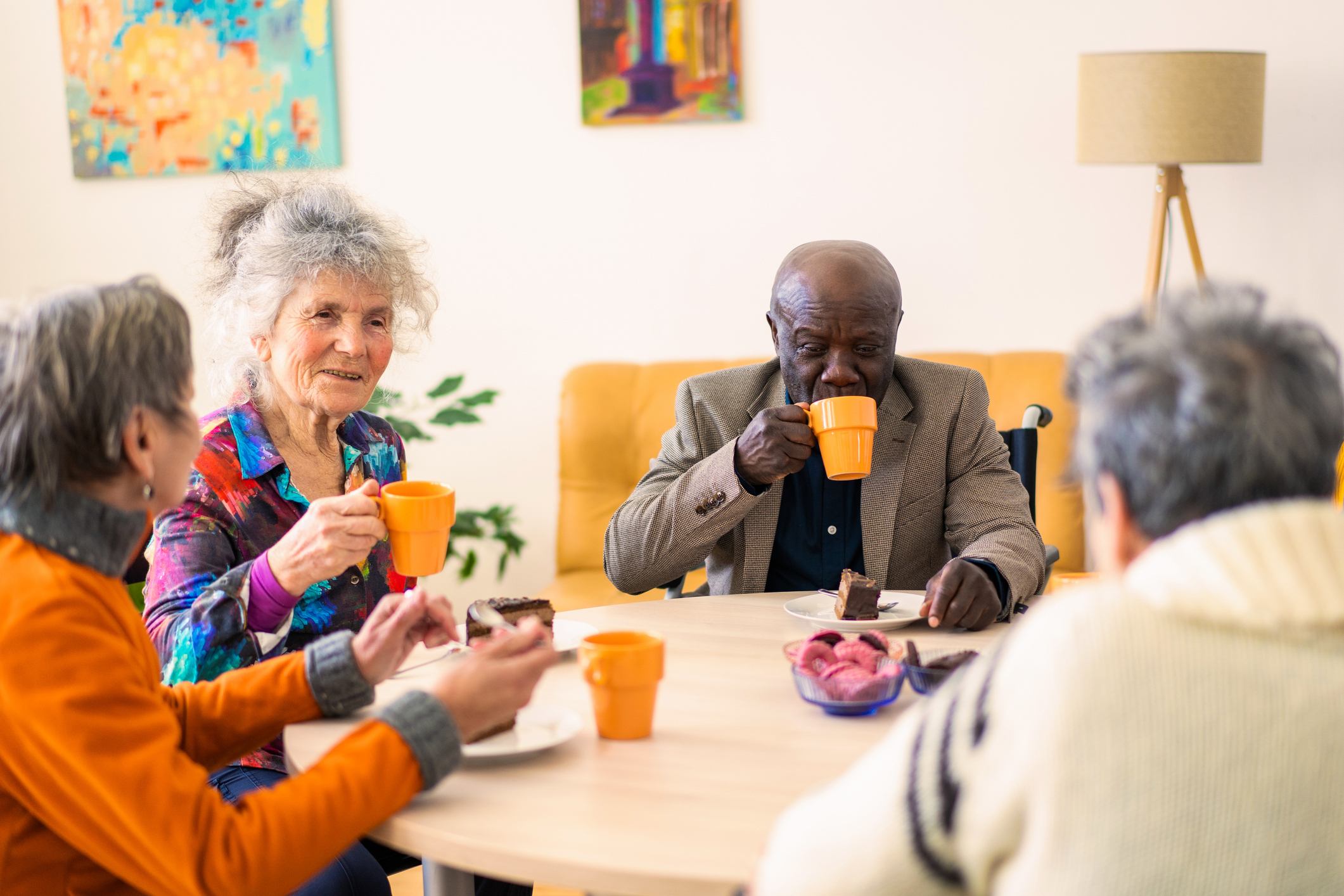 Group of senior friends enjoying afternoon tea  together