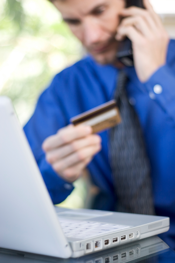 Man on phone_holding credit card_computer open_cmp