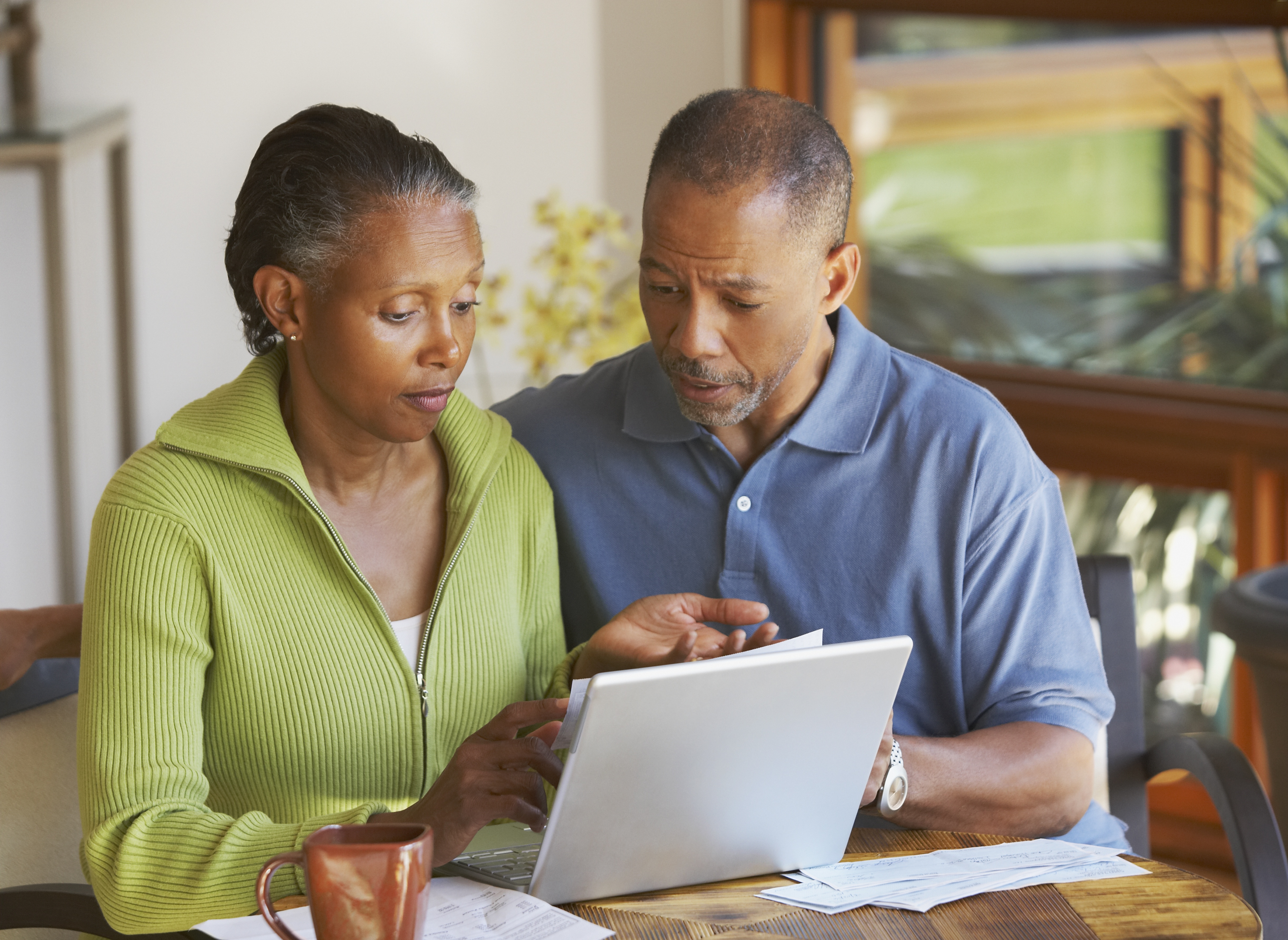 Senior African American couple paying bills