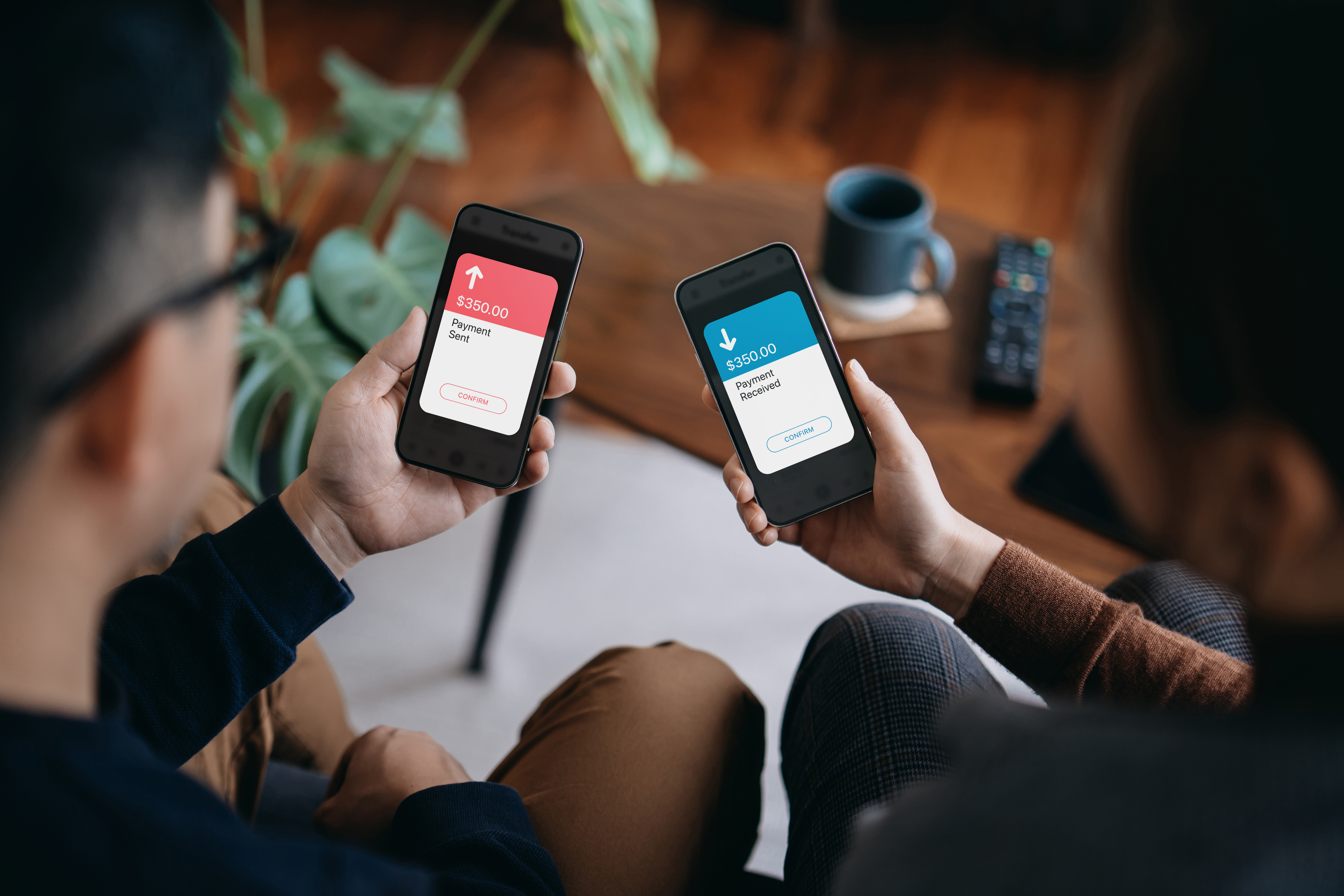 Young couple holding smartphone, sending and receiving money through digital wallet, using online banking mobile app device. Friends holding mobile phone to activate NFC. Contactless payment. Smart banking with technology