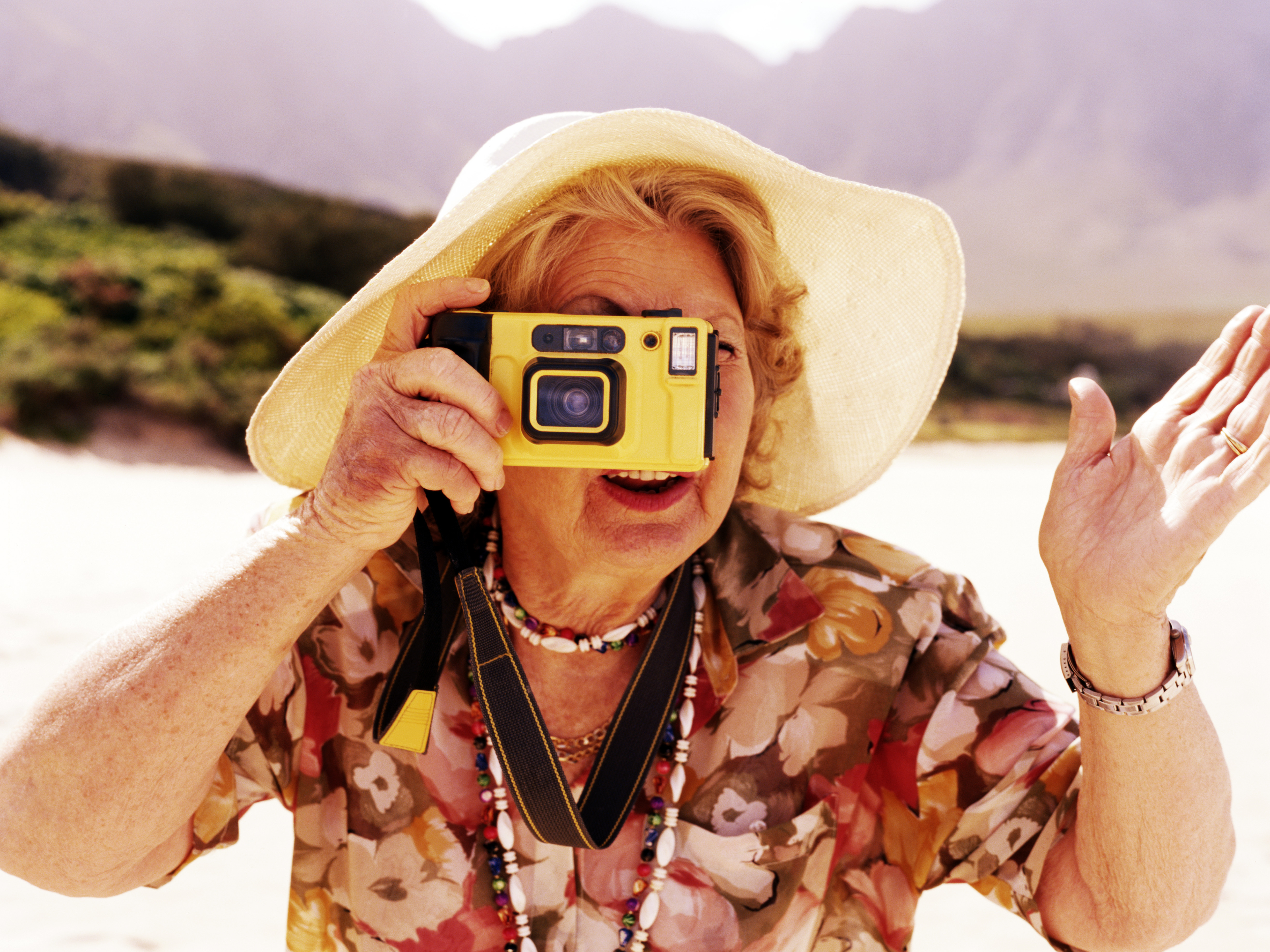 Senior woman taking photograph outdoors