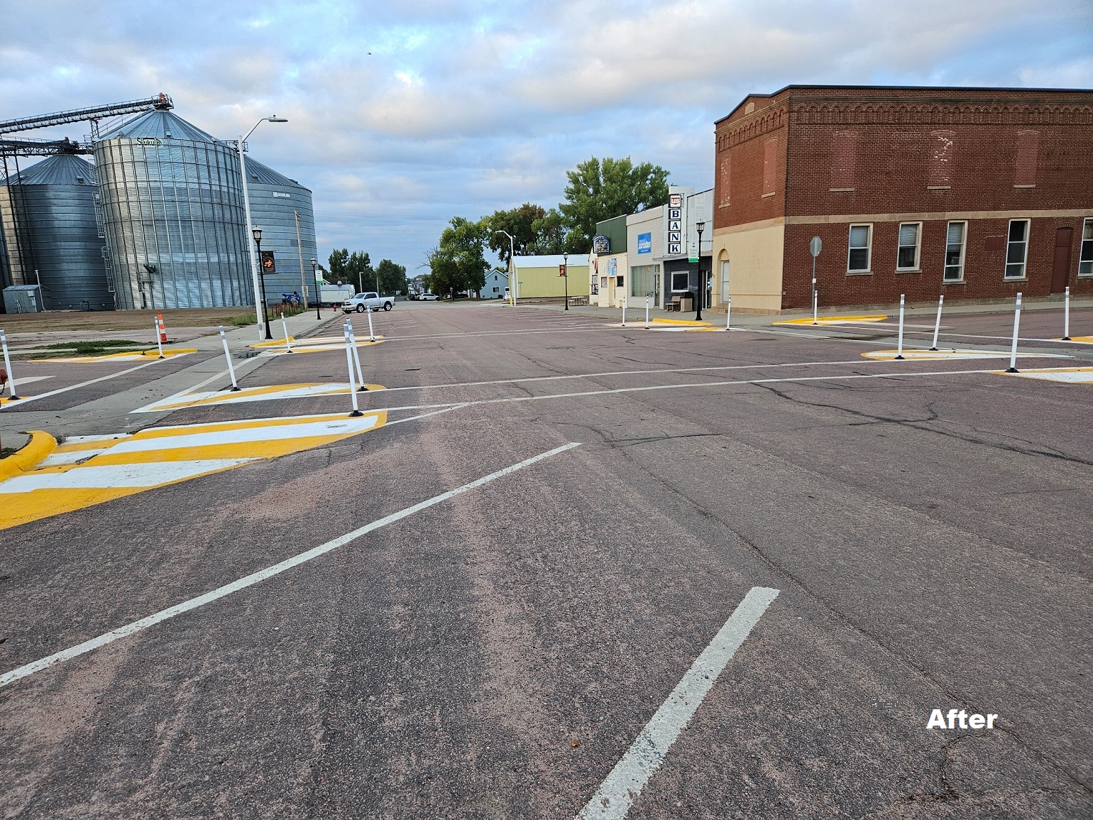 Picture of the Main Street intersection in Hartford, South Dakota, with yellow and white curb extensions and white crosswalks painted on the streets.