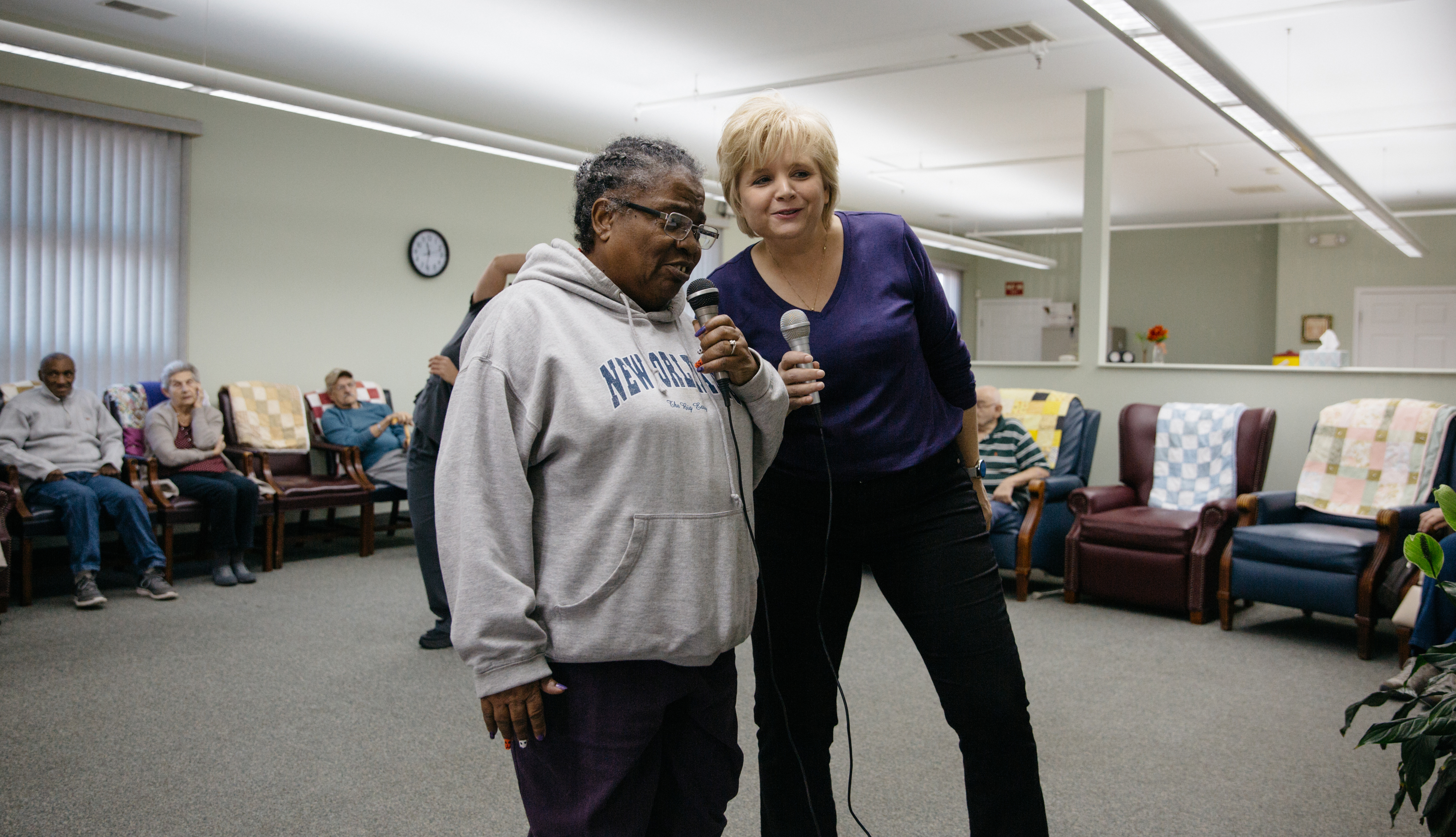 Two women sing karaoke