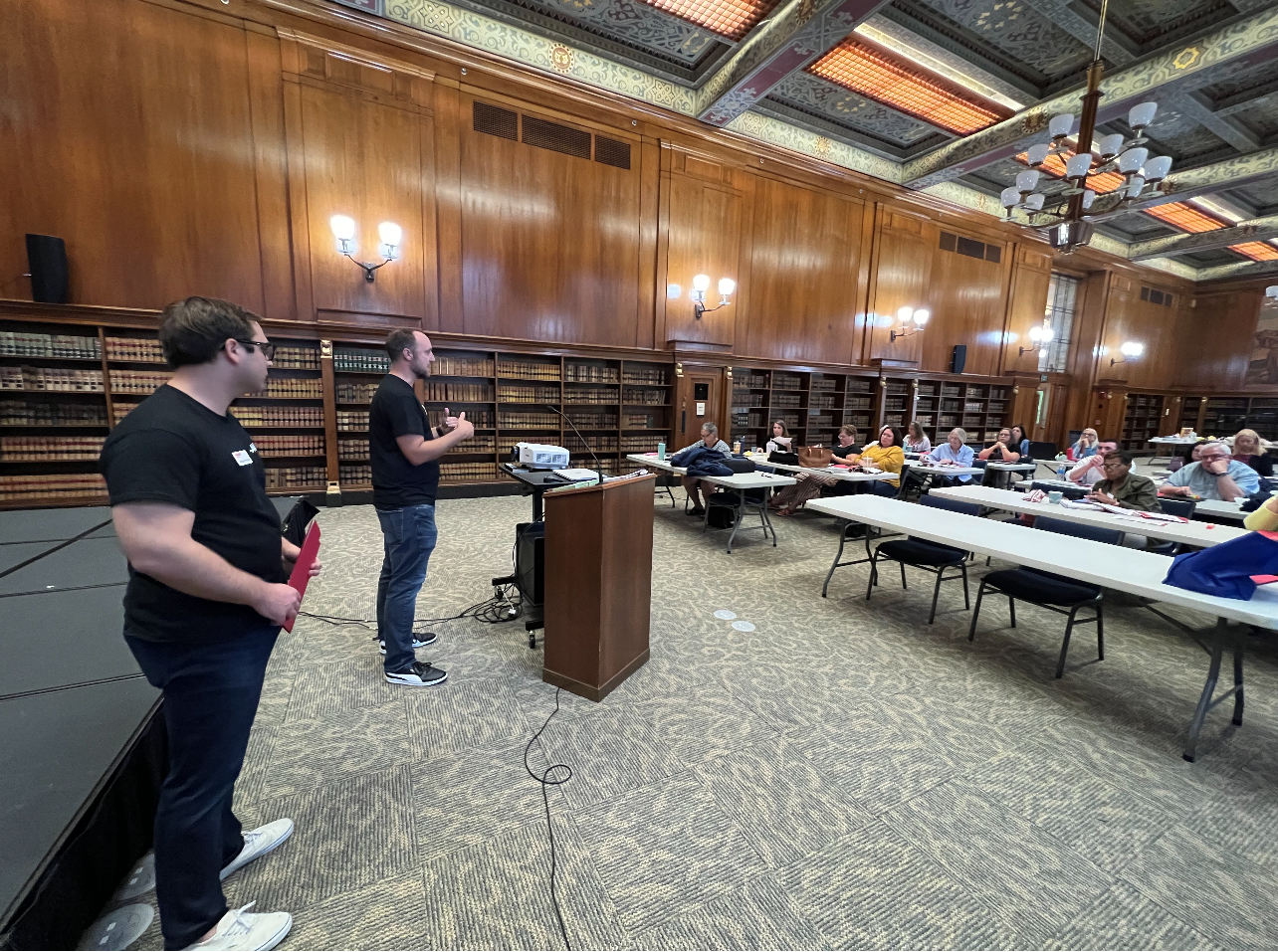 AARP Indiana staff members Addison Pollock and Jason Tomcsi address the ombudsmen. 