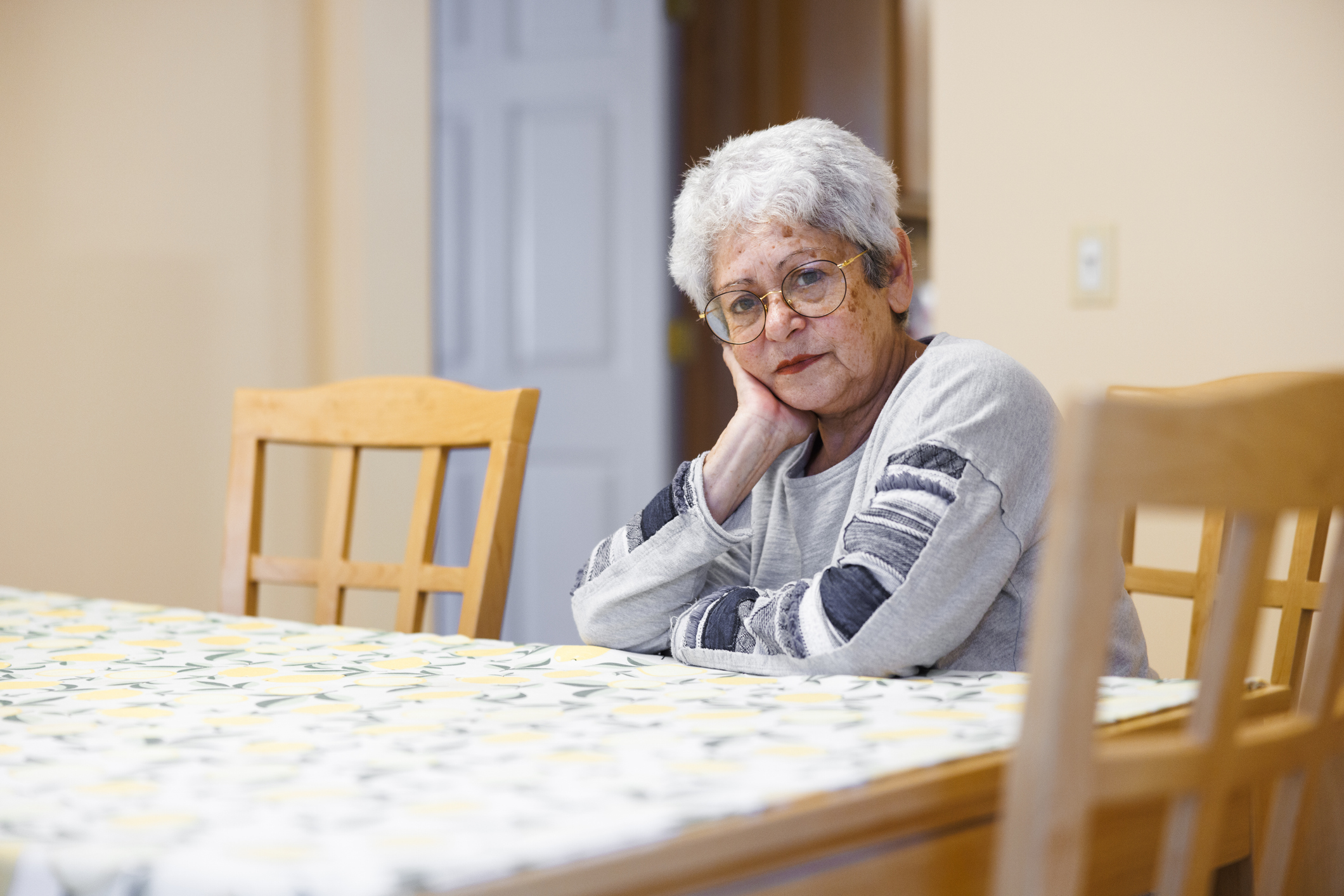Reflection time. Jewish senior woman, 76, ponders at kitchen table.