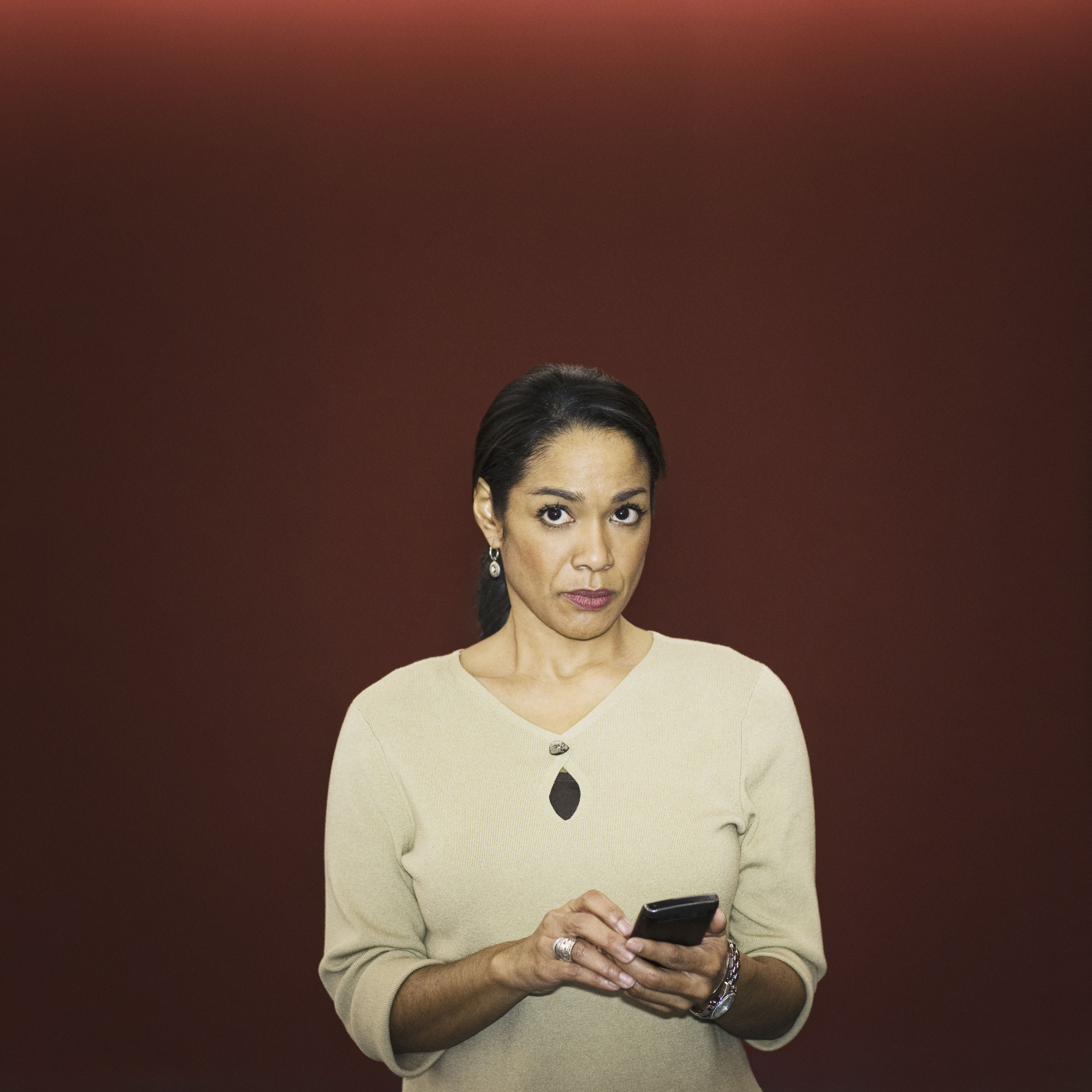 Black businesswoman text messaging on cell phone