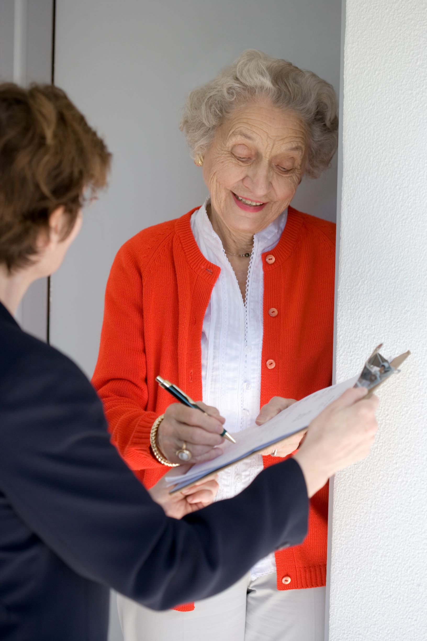 Smiling senior woman completing form