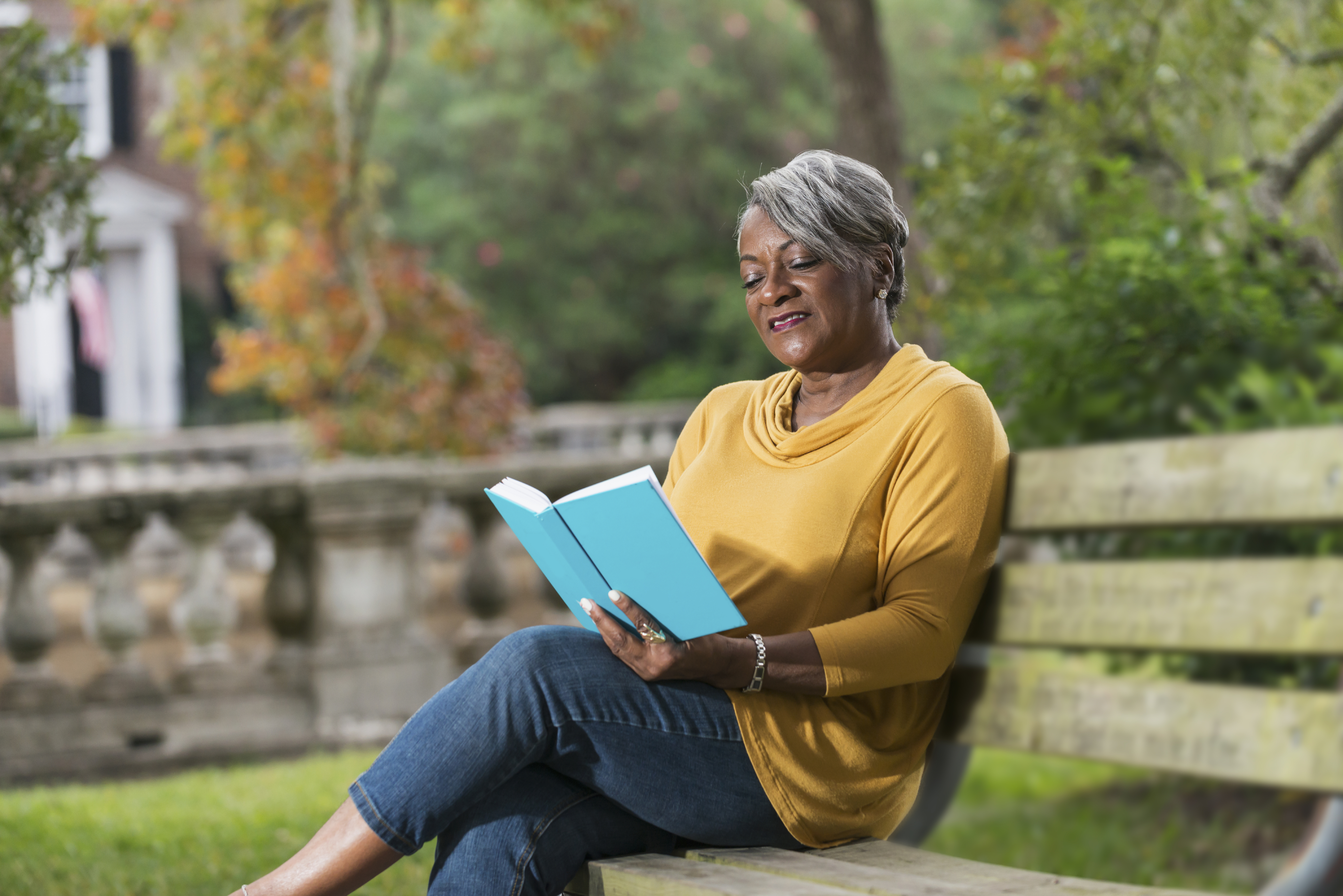 Senior black woman reading a book