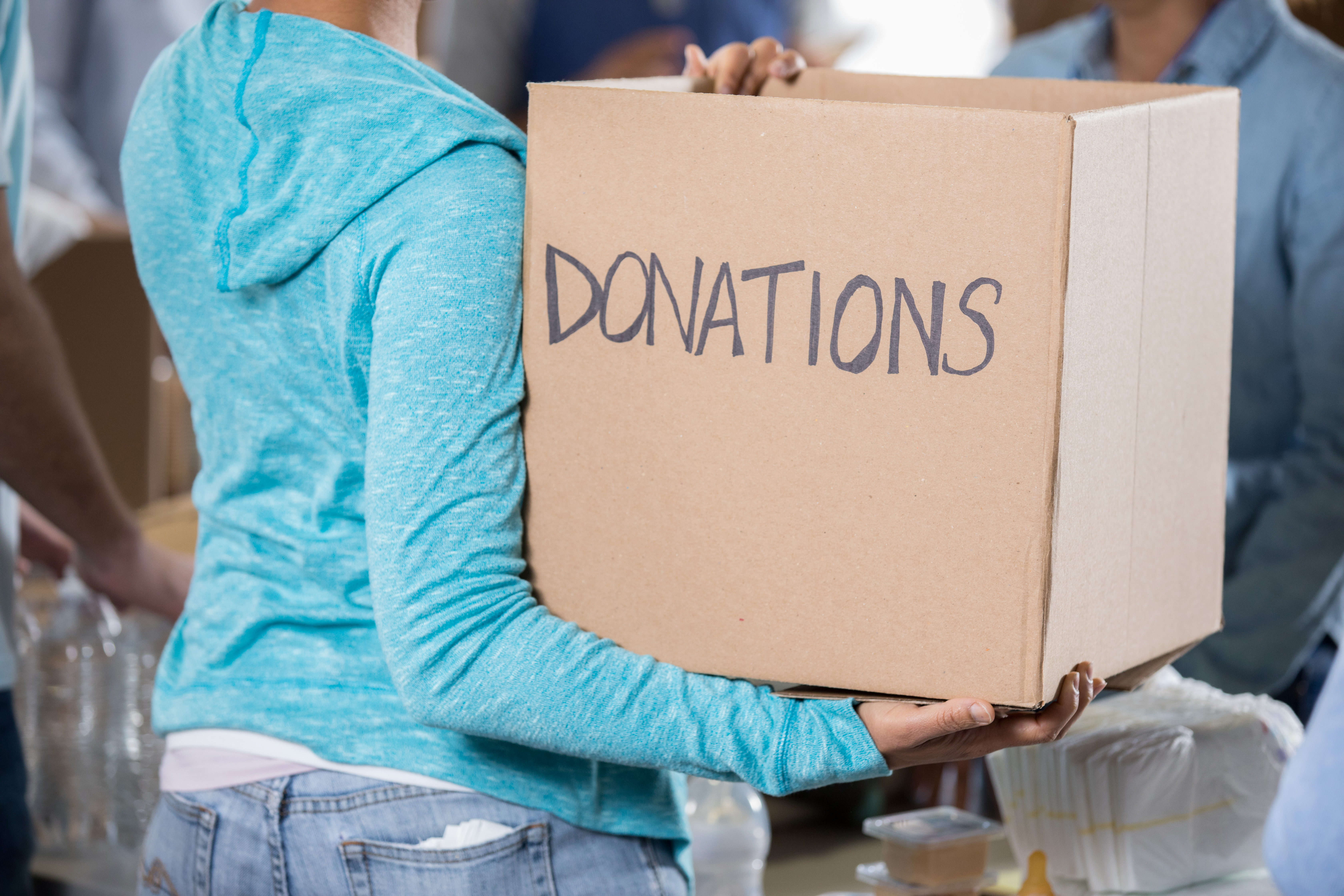 Unrecognizable woman holding donation box