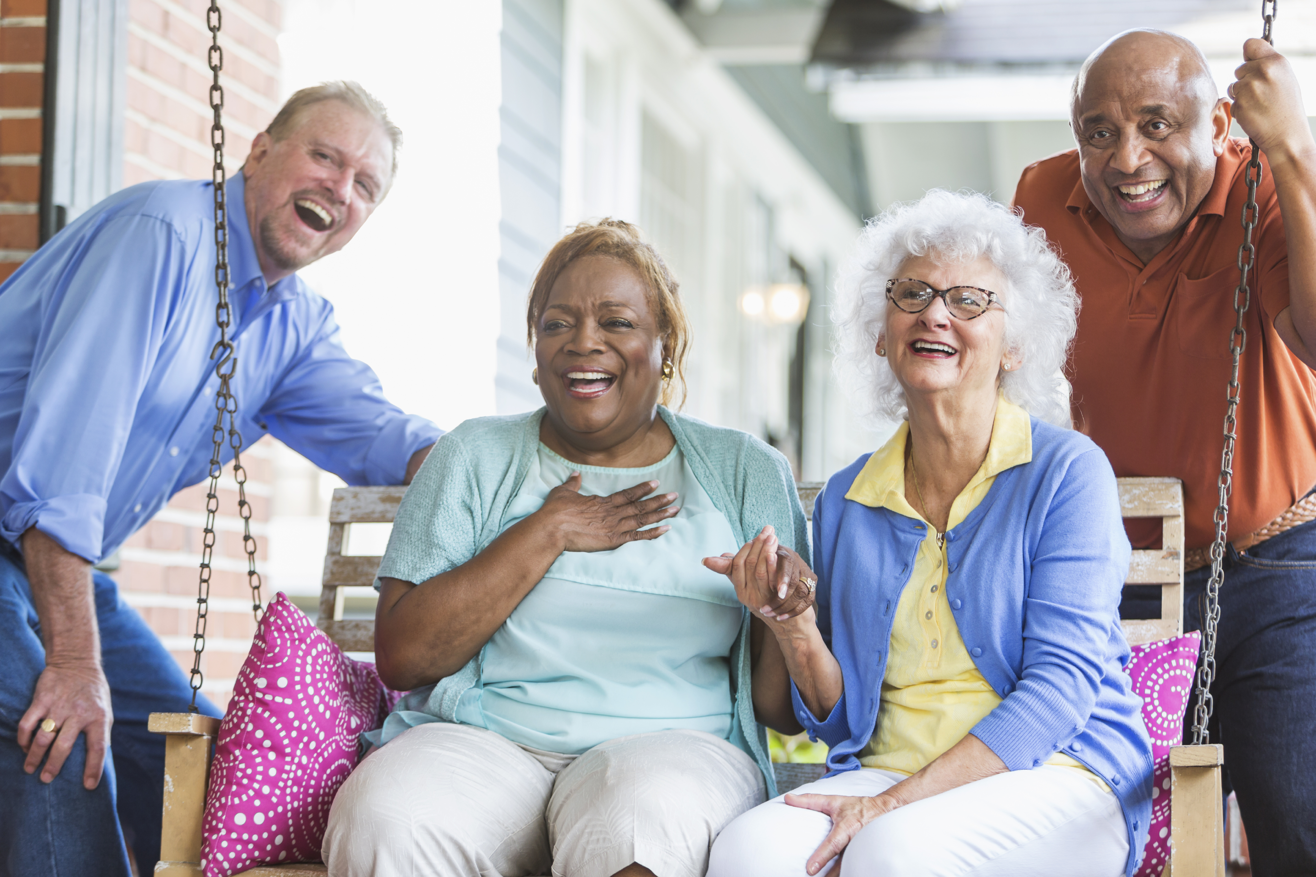 Group of multiracial seniors on porch swing