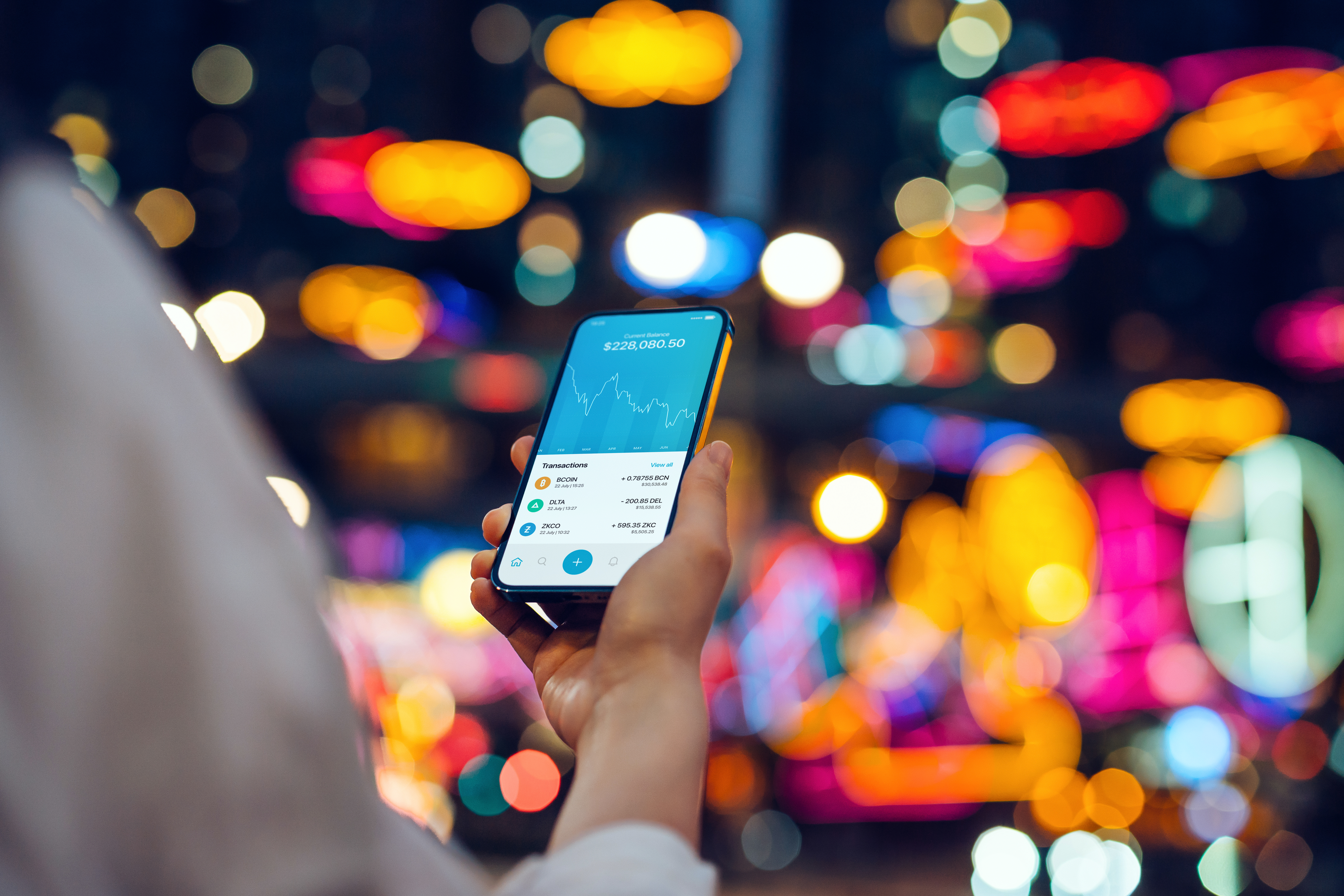 Young woman using NFT investment wallet on smartphone in illuminated city, working with blockchain technologies, investing NFT on cryptocurrency, digital asset, art work and digital ledger. Showing a downward trend on the trading in cryptocurrency market