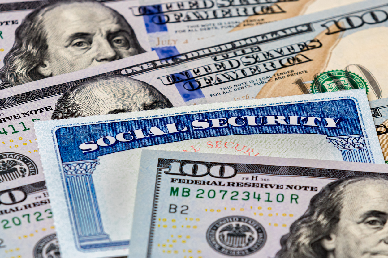 Social Security benefits identification card with 100 dollar bills