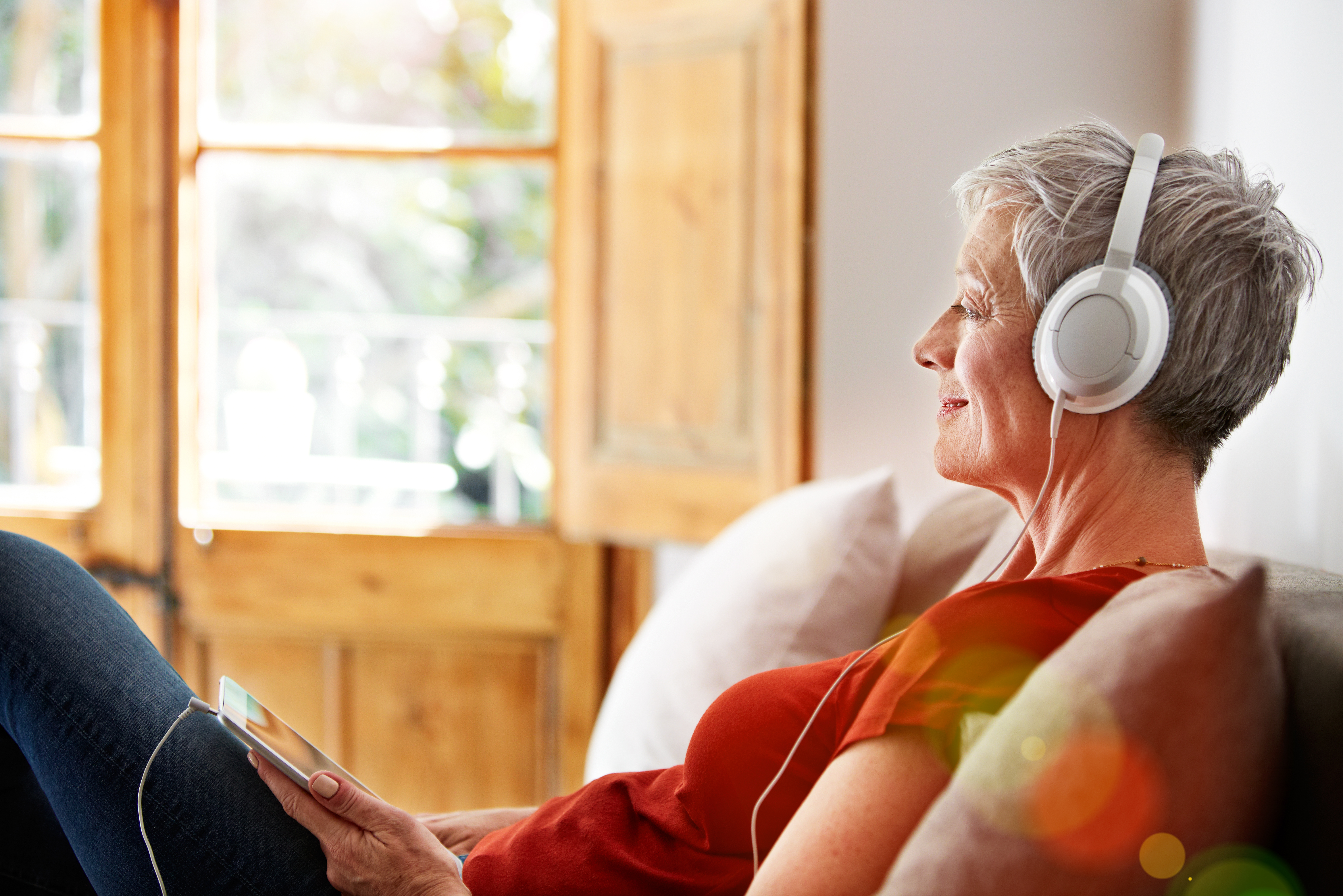 Woman listening to music with headphones | Getty licensed