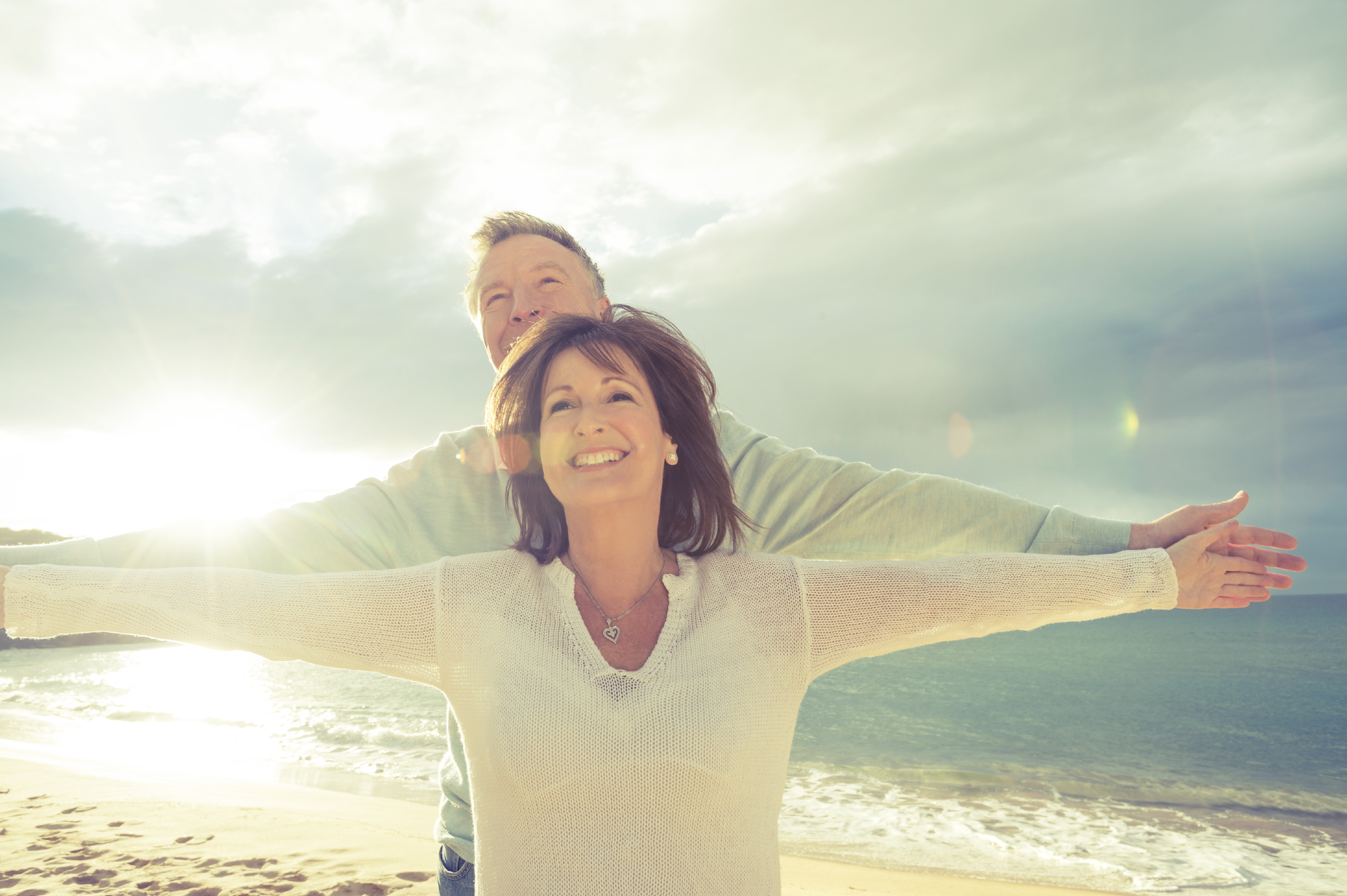 Mature couple holding out their arms