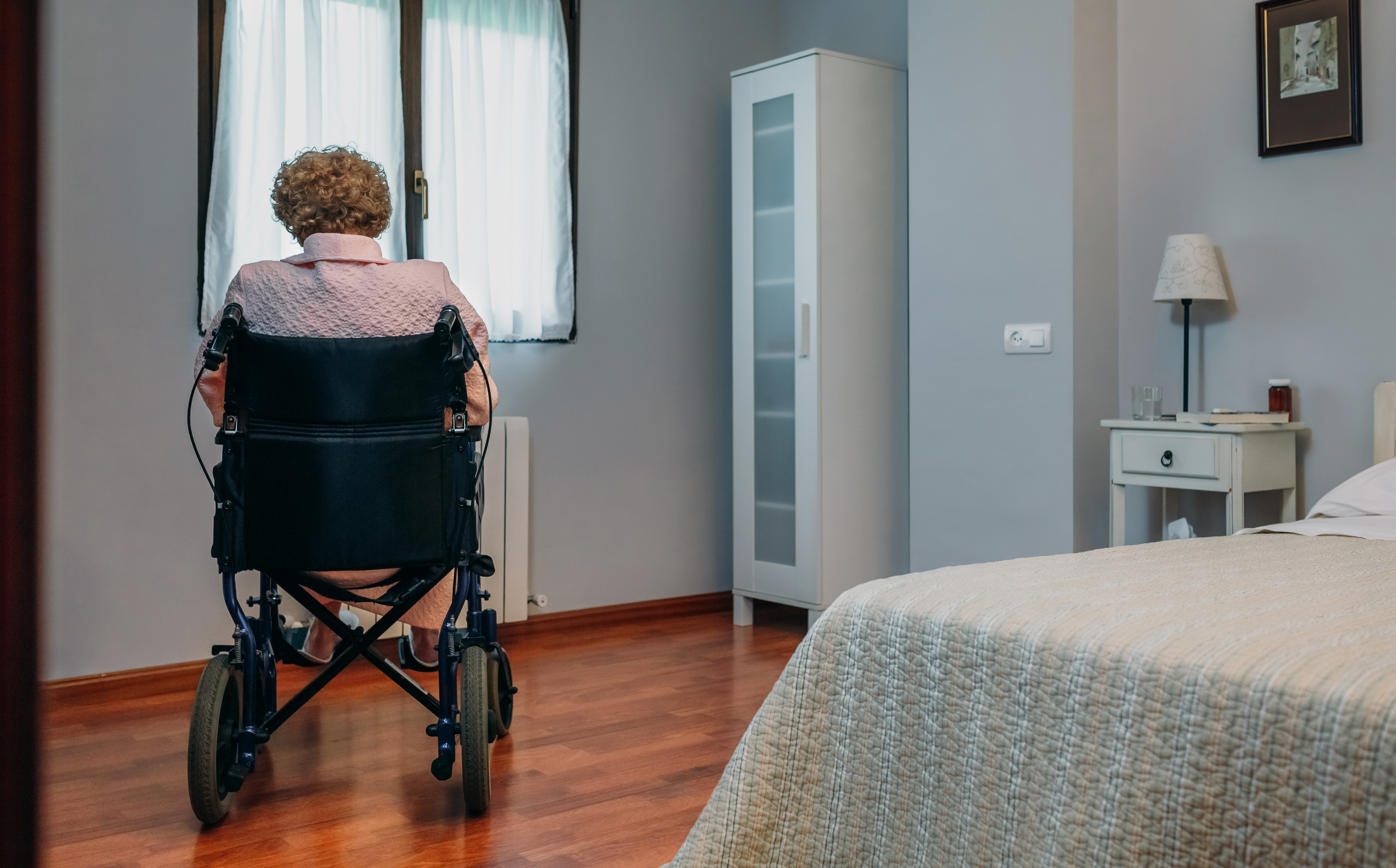 Senior Patient Sitting On Wheelchair In Hospital