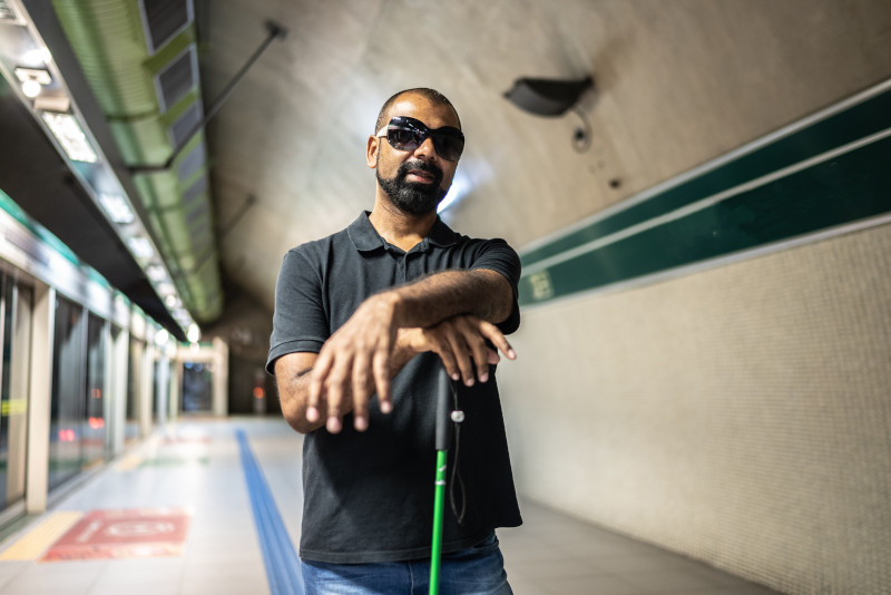 Portrait of a blind man at a subway station