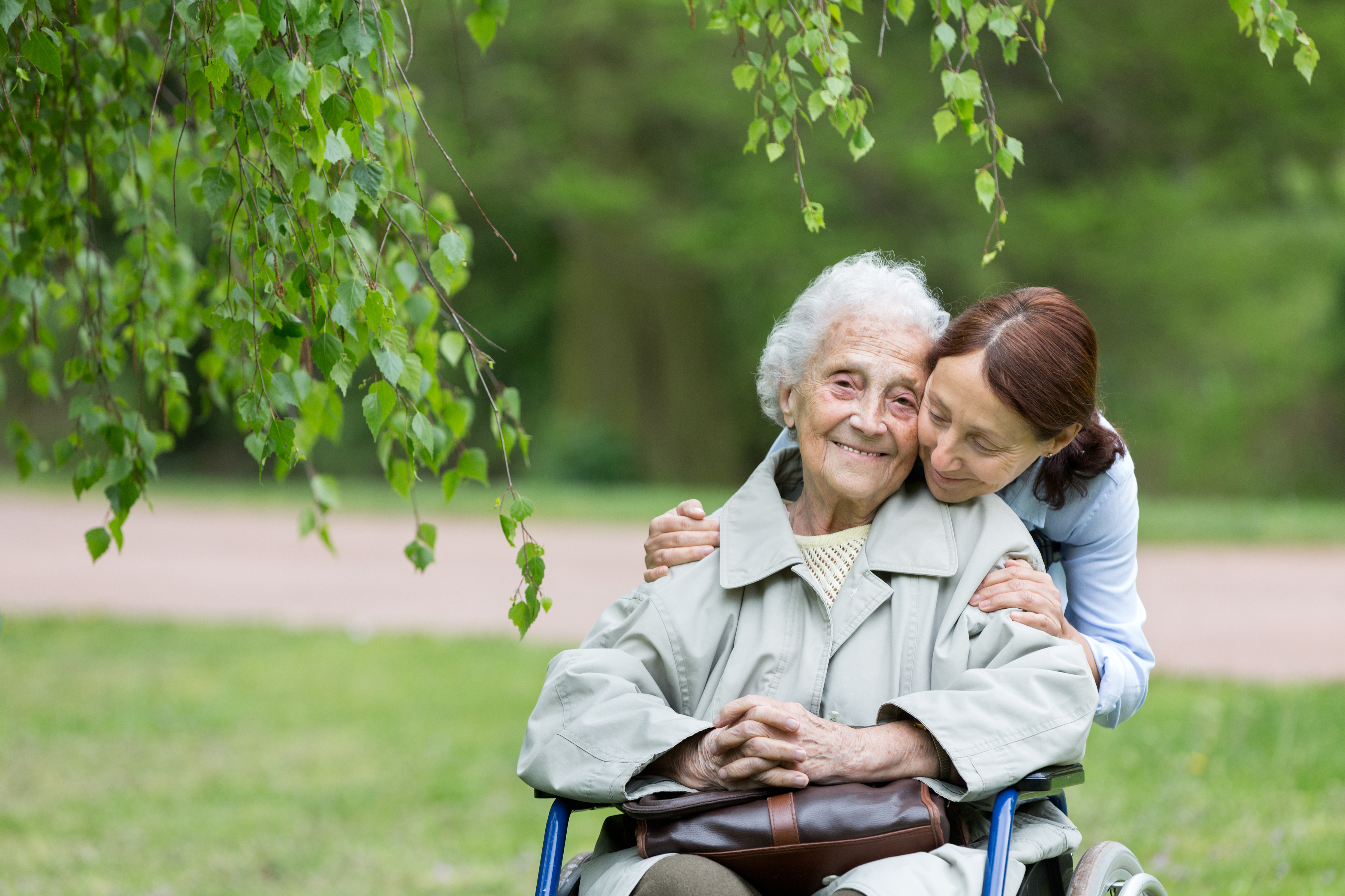 Senior woman with caregiver in the park