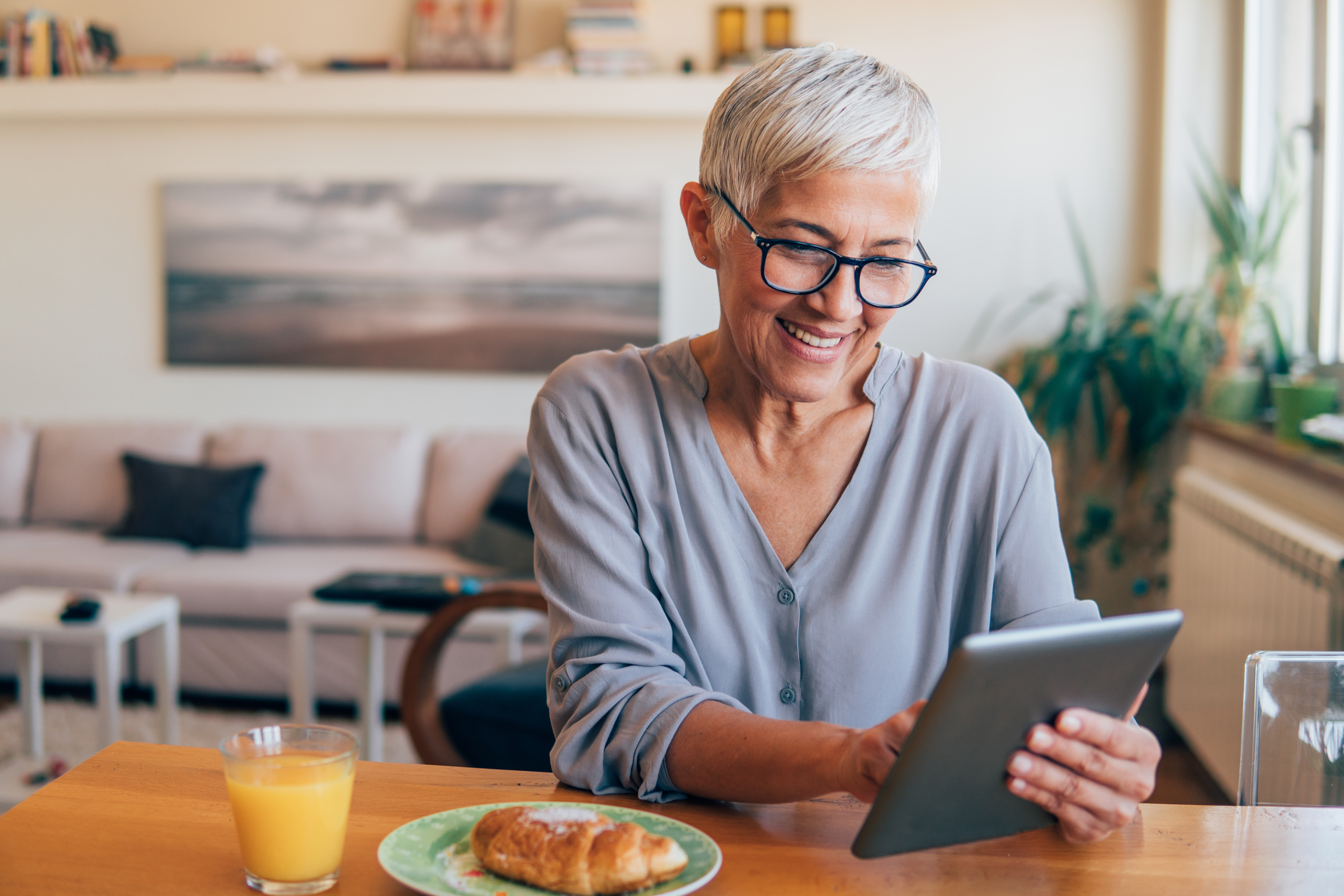 Happy woman working on digital tablet