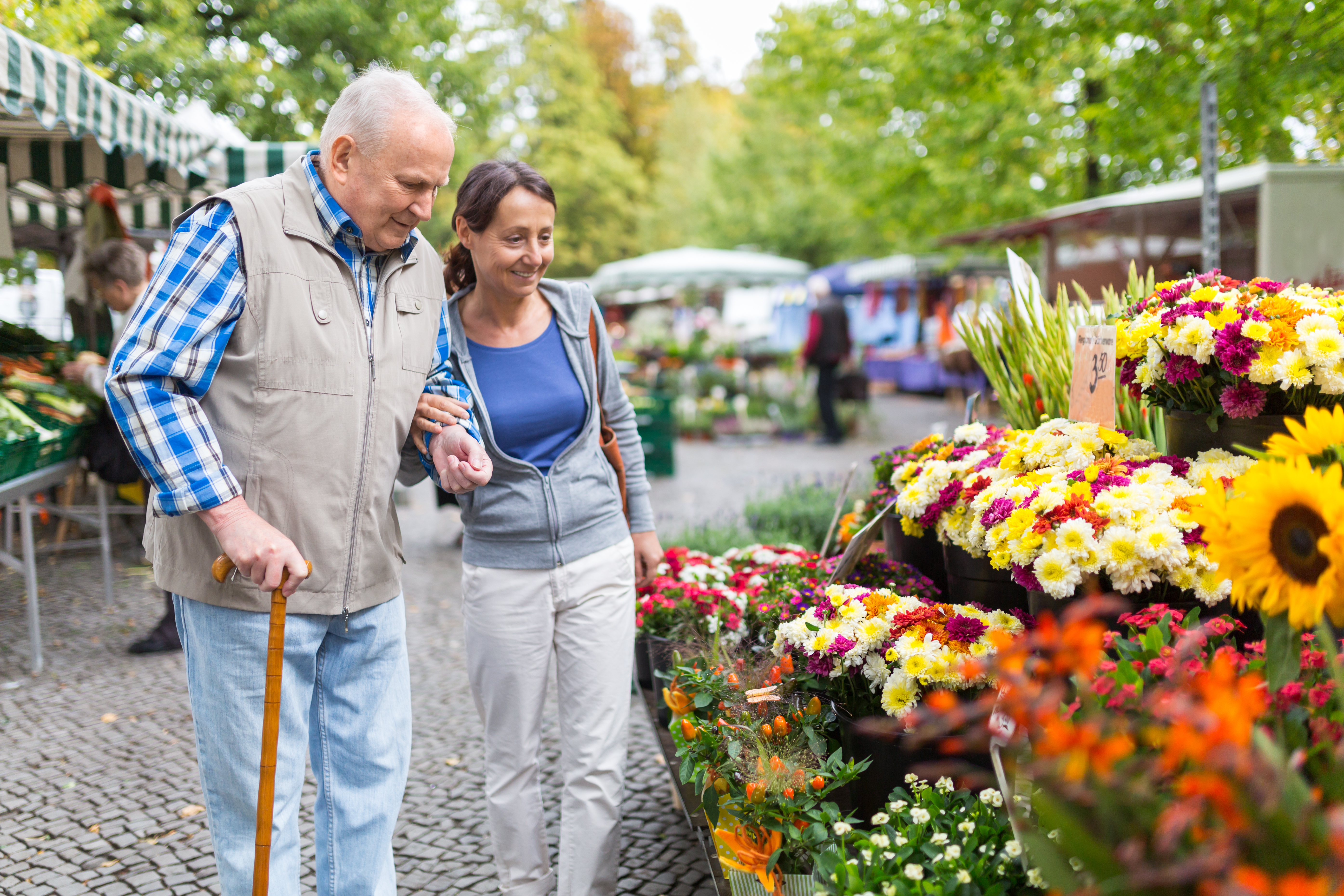 Senior man with caregiver shopping