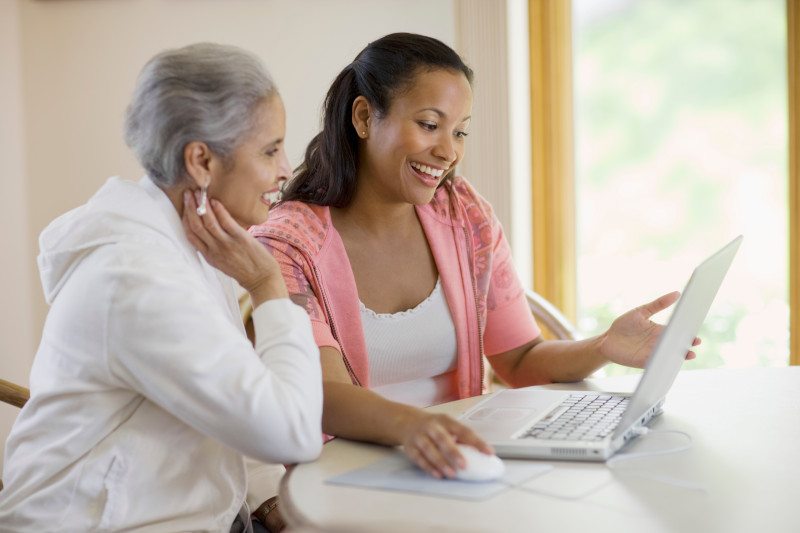 Mother and daughter sharing computer