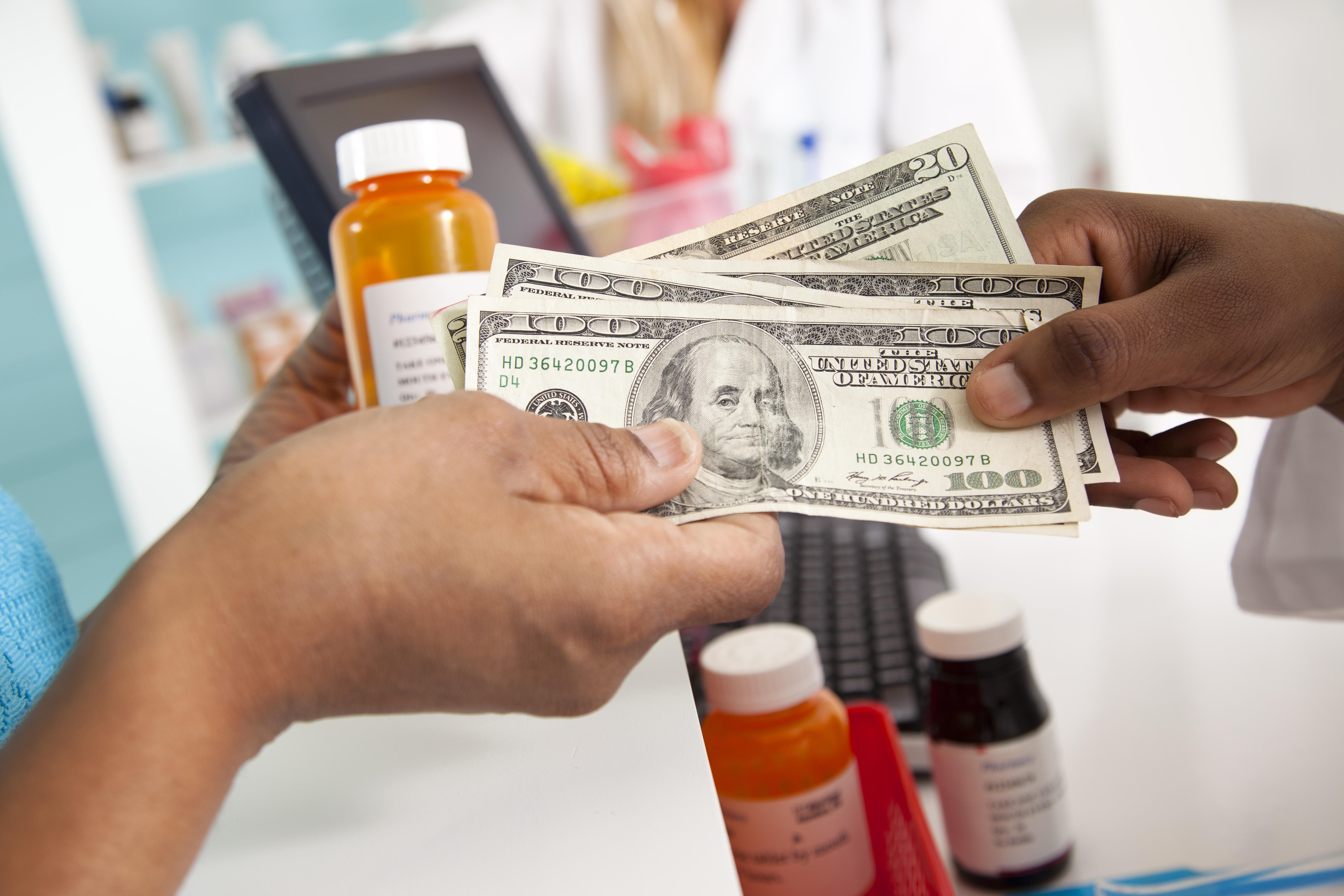 Medical: Customer pays for expensive prescriptions in pharmacy.