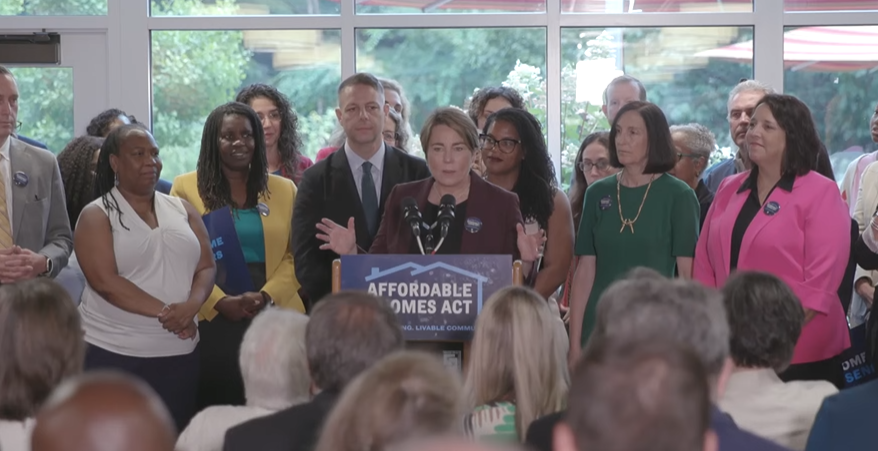 Gov. Healey at podium at the Golda Meir House in Newton where she signed the Affordable Homes Act into law.