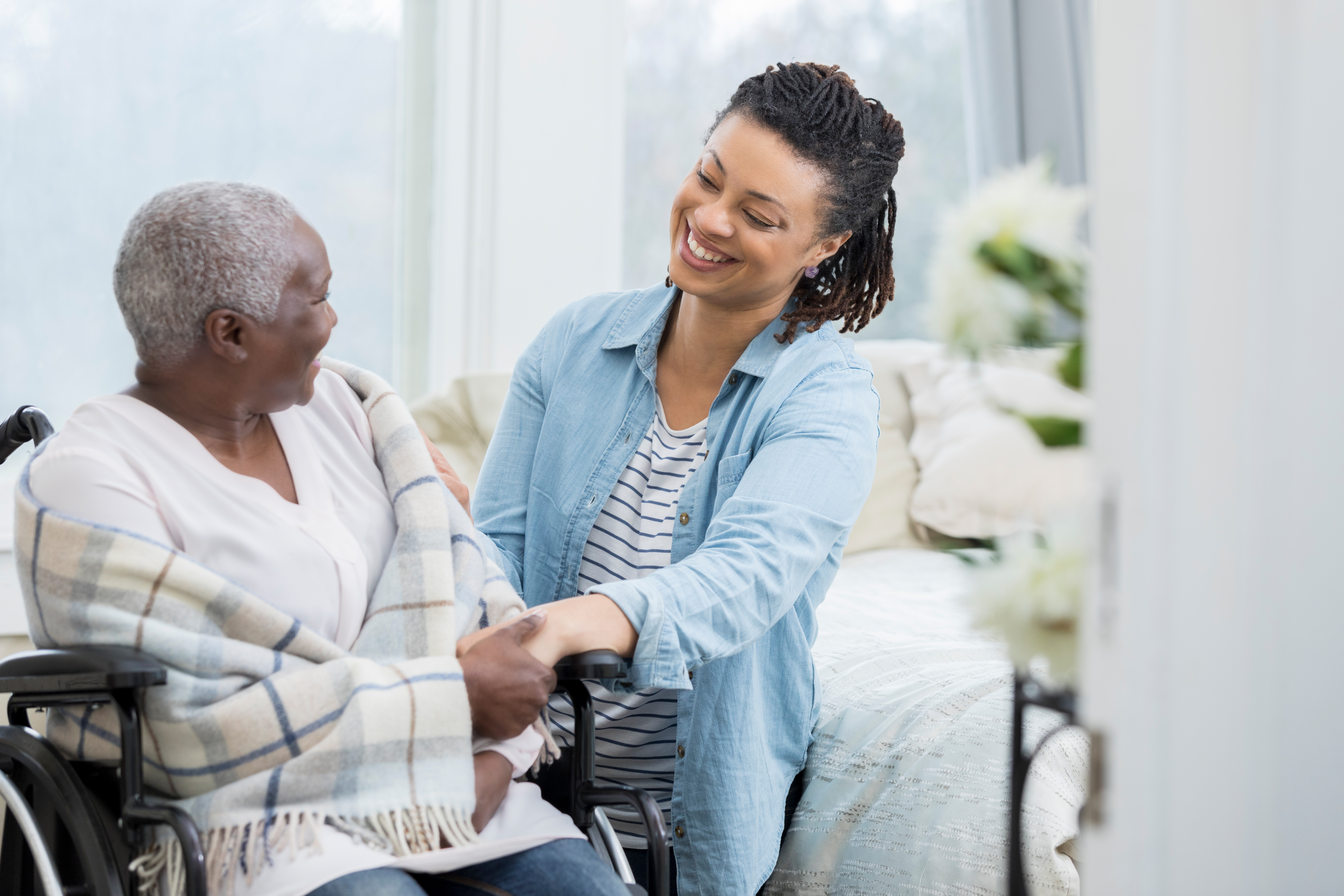 Happy woman helps elderly mother