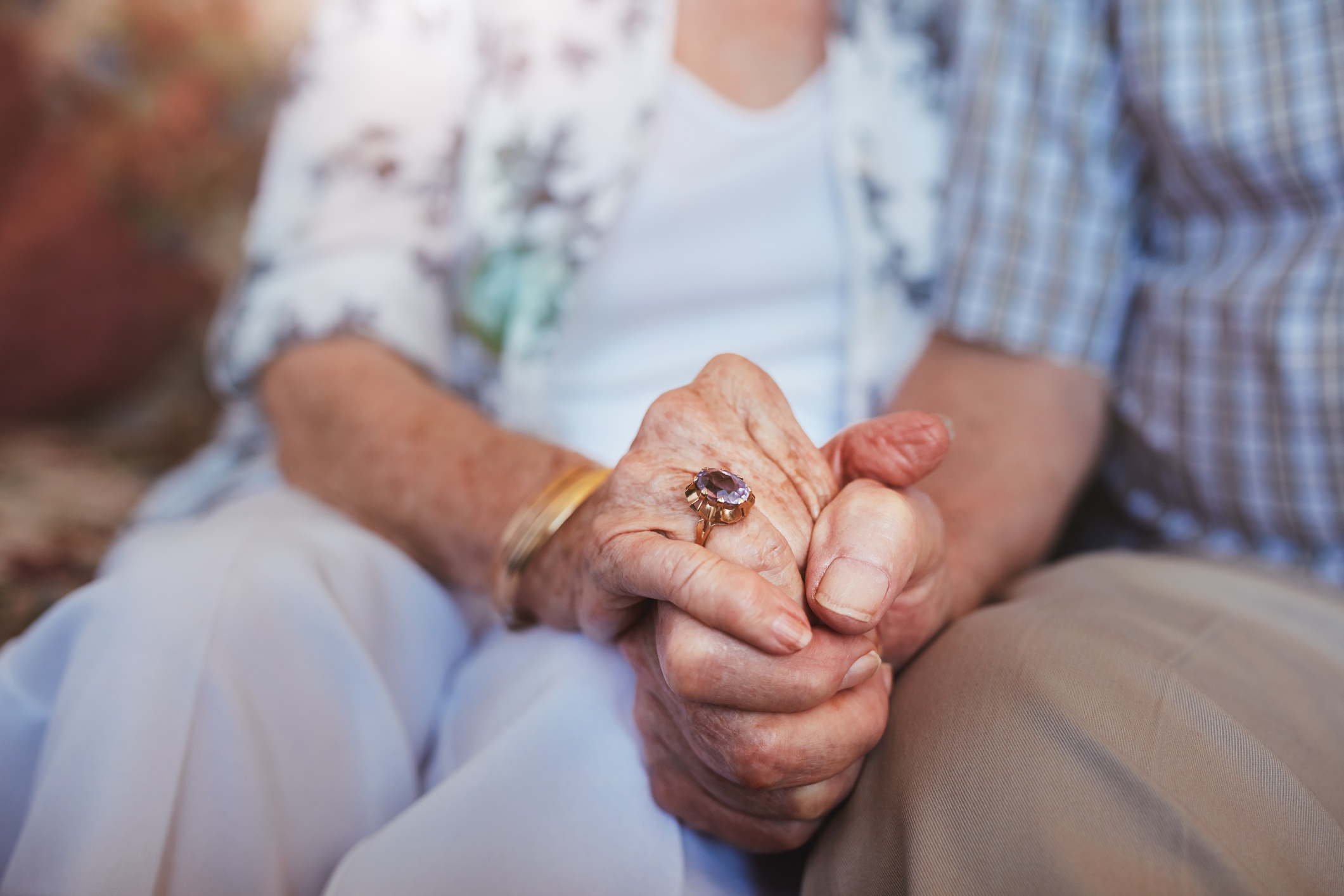 Elderly couple holding hands