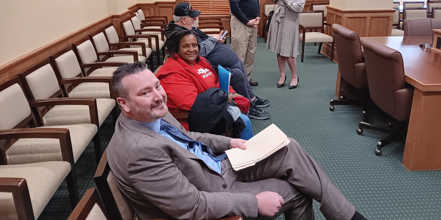 Chris McCoy, Rita Qualls, and members of the AARP Arkansas veterans team await testimony regarding caregiving tax credit legislation.