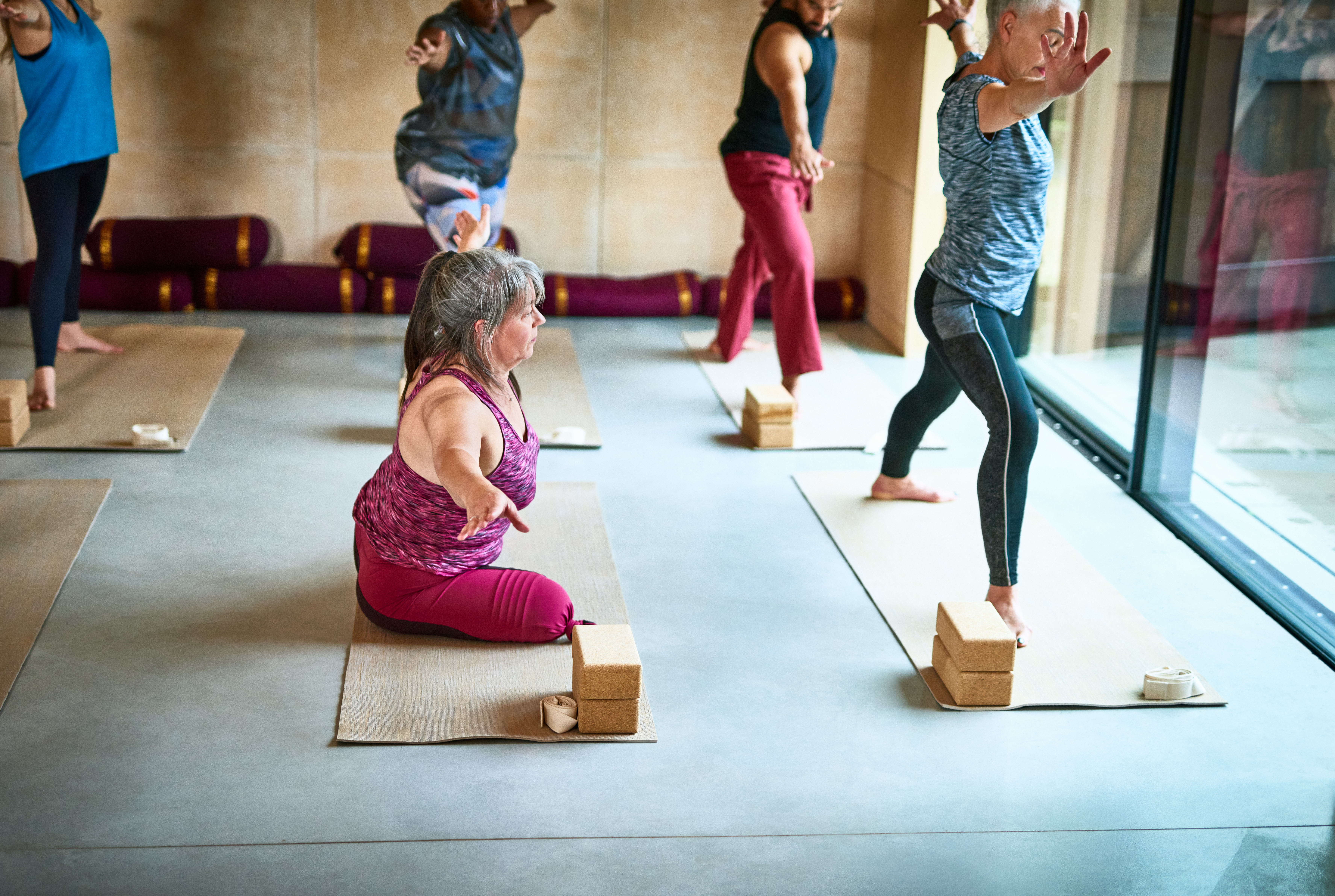 Female amputee on yoga mat with arm out