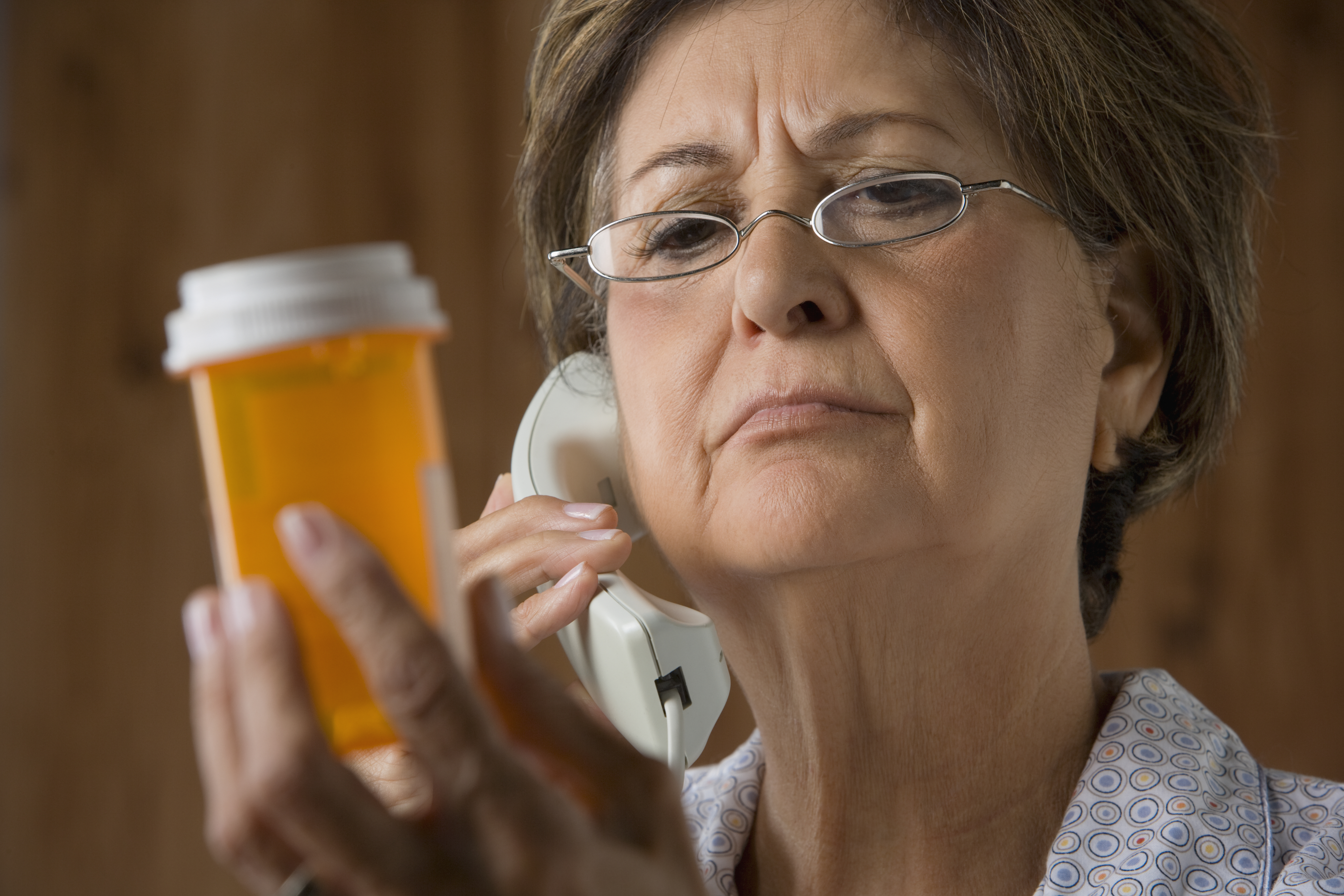 Senior Hispanic woman calling in prescription