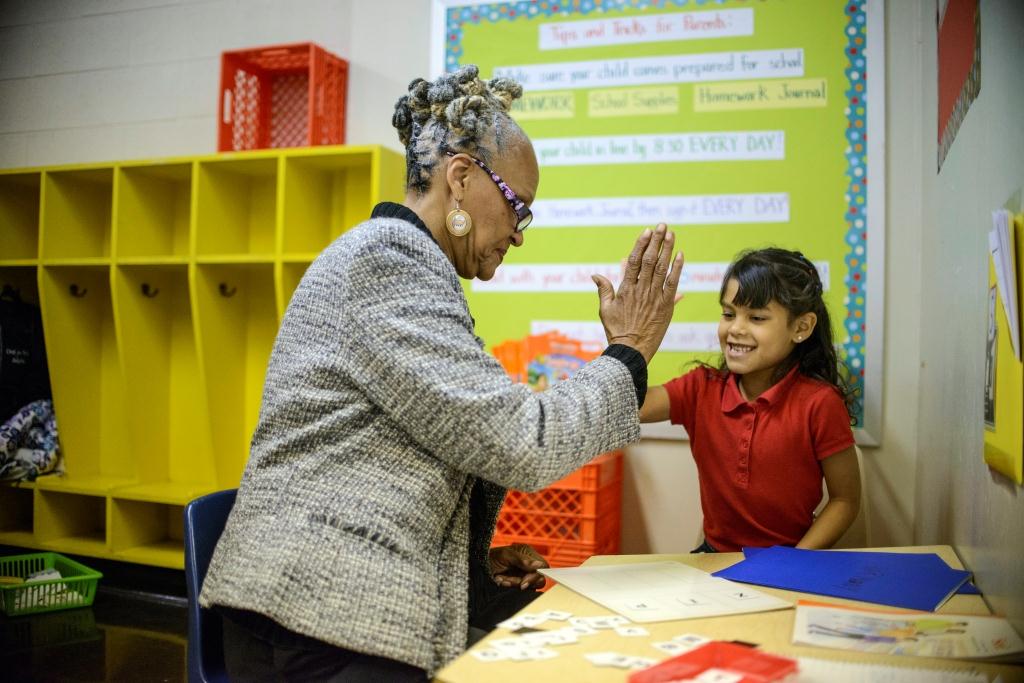 Philadelphia, Pennsylvania - October 24, 2013:Harmony, a first grader in Delilah Montemayor's class is tutored by AARP Experience Corps volunteer Margaret Plenty at Cramp Elementary School.