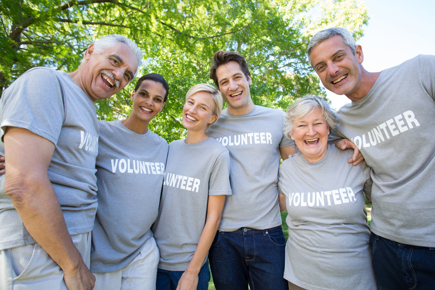 Happy volunteer family smiling at the camera