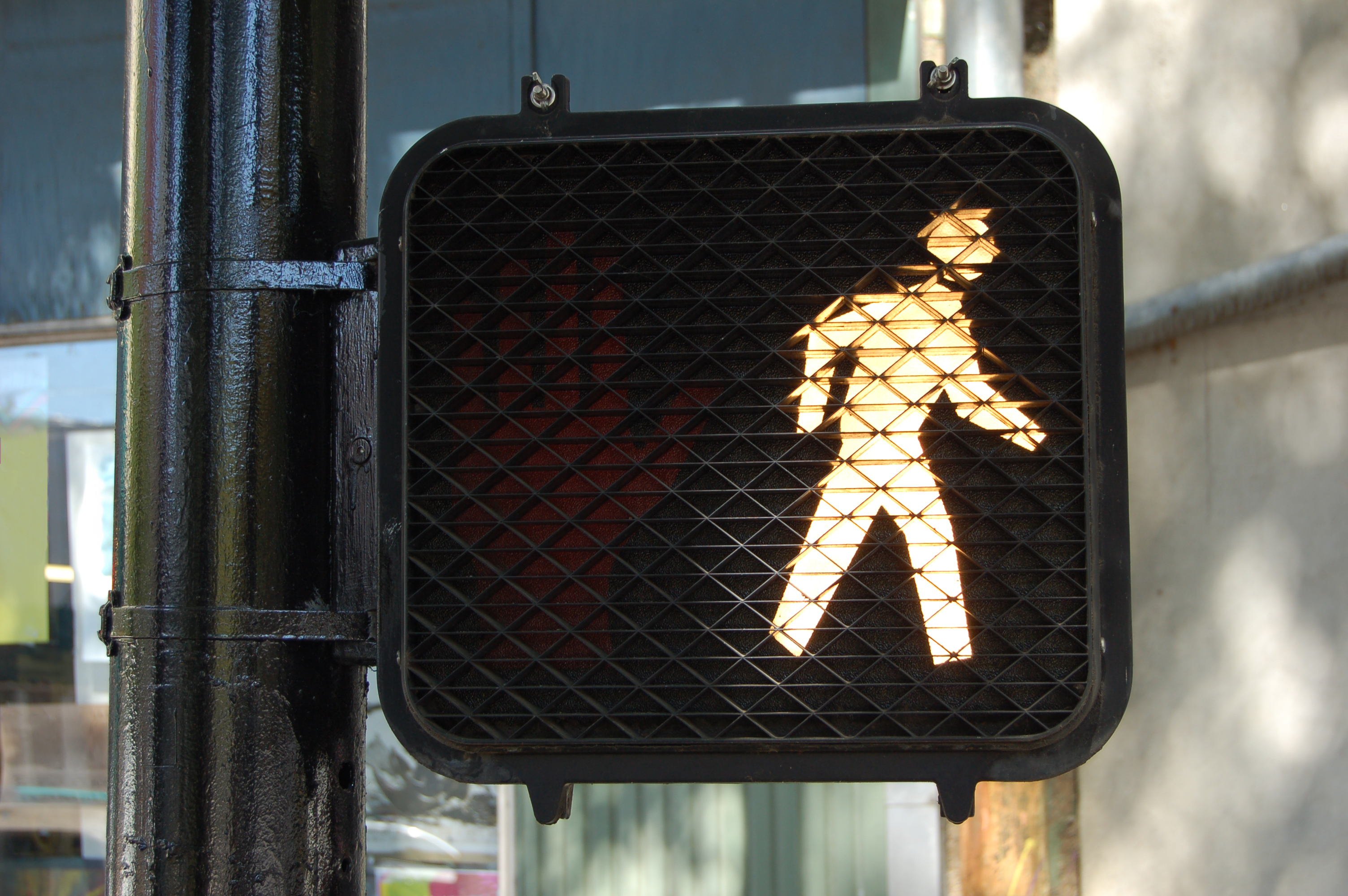 An illuminated walk street sign