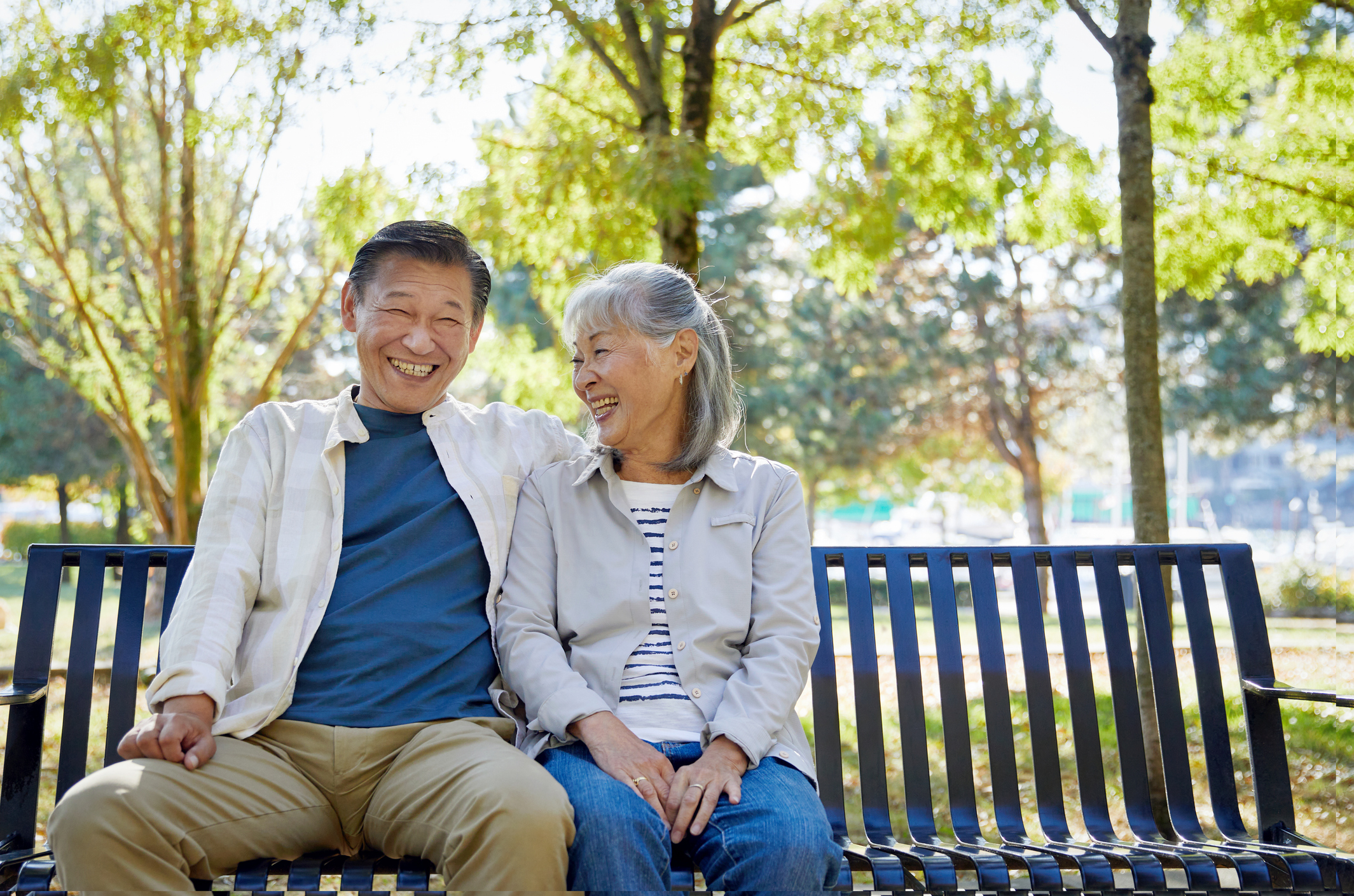 Asian couple relaxing together in park