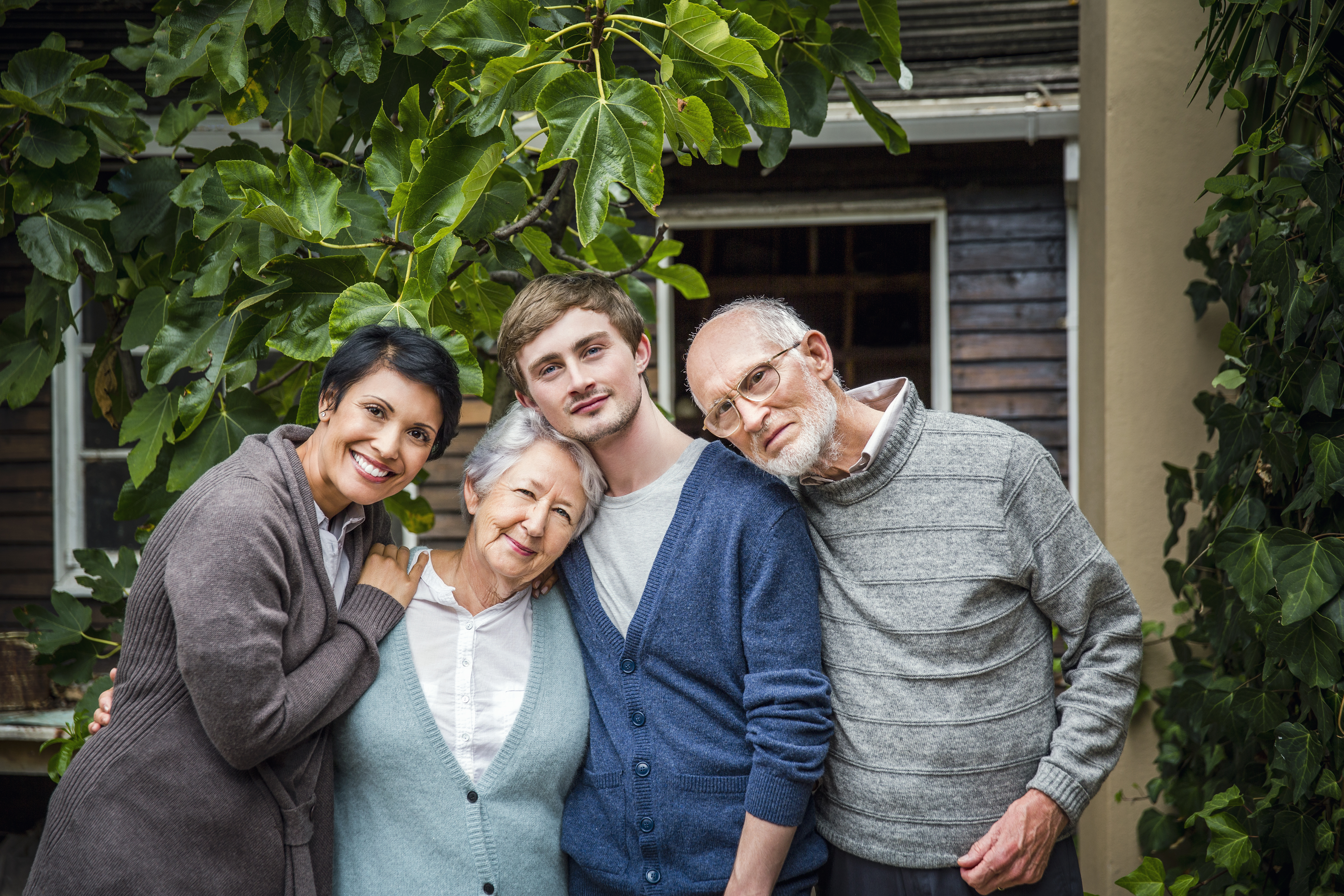 Multi-generation family standing together in yard