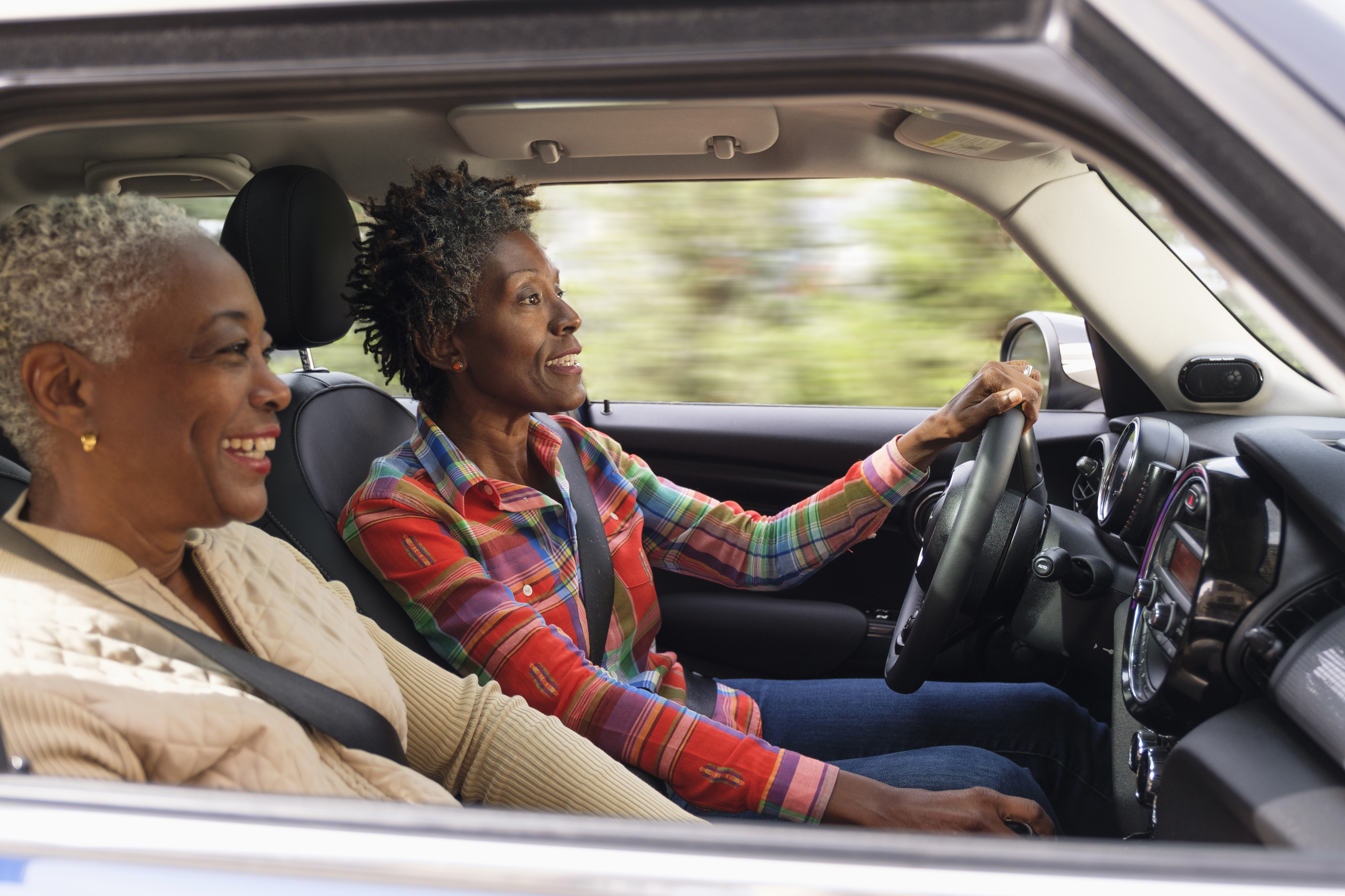 Two smiling women in car