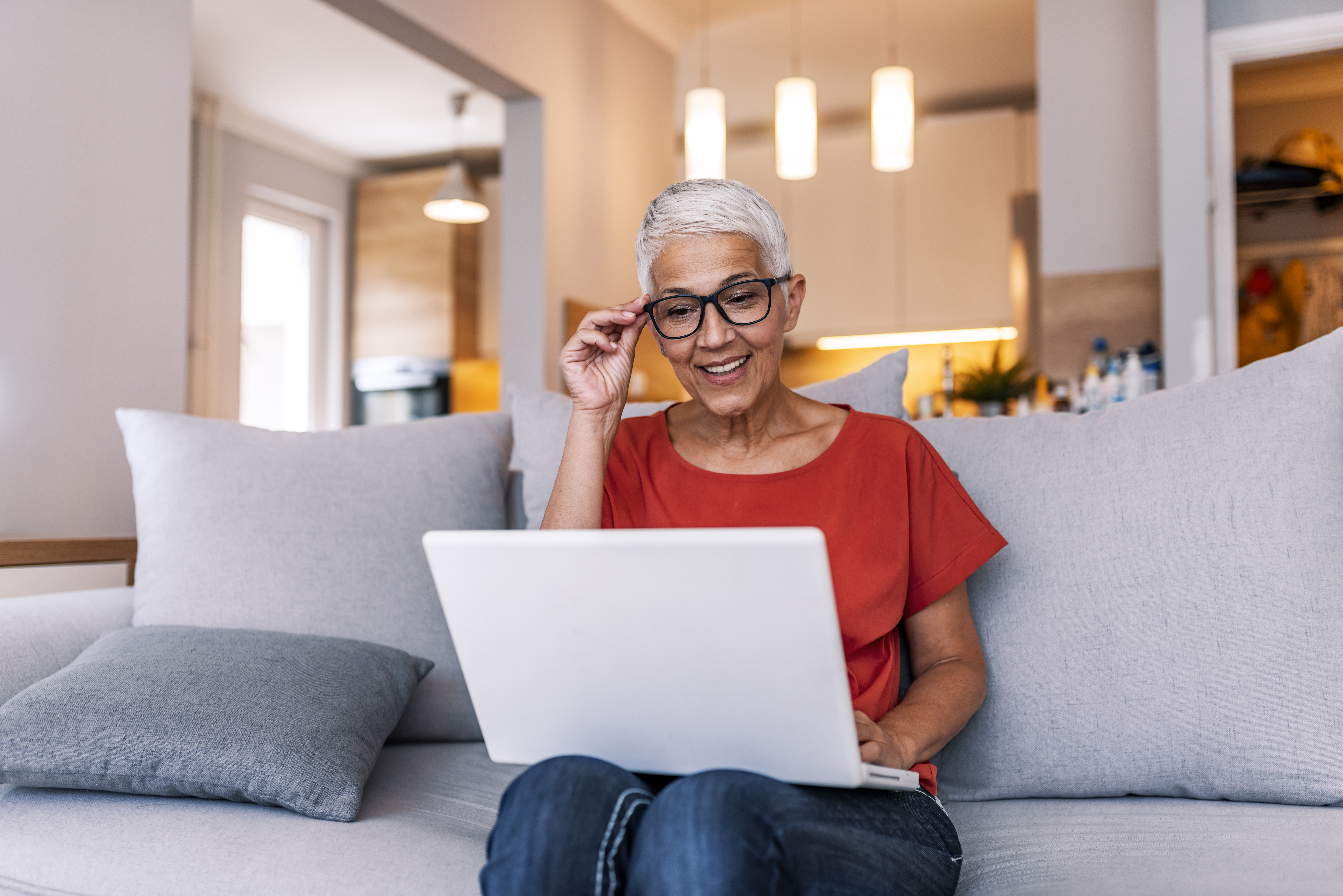 Mature woman working on laptop while sitting