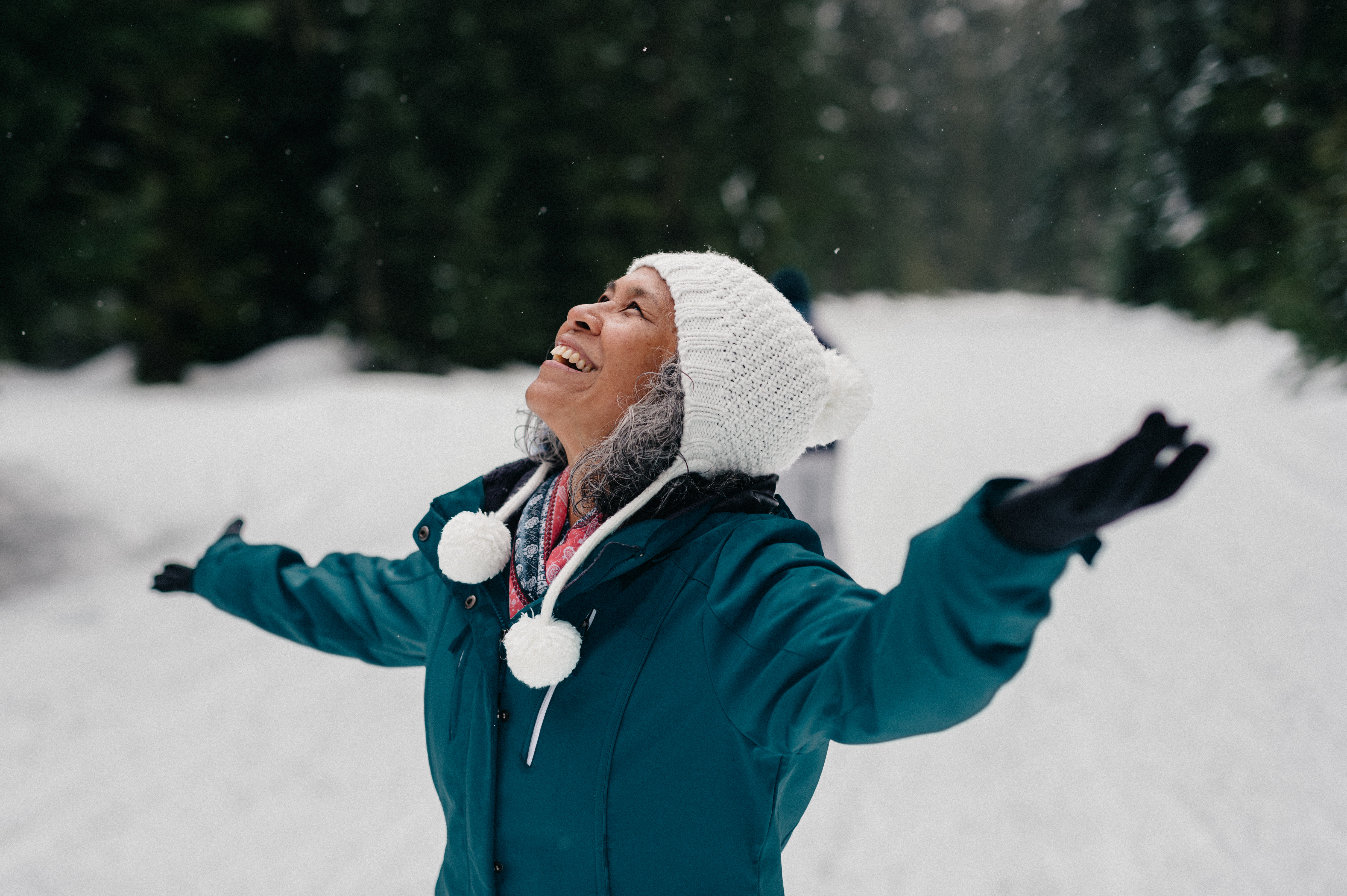 Woman enjoys the snowfall at the mountain