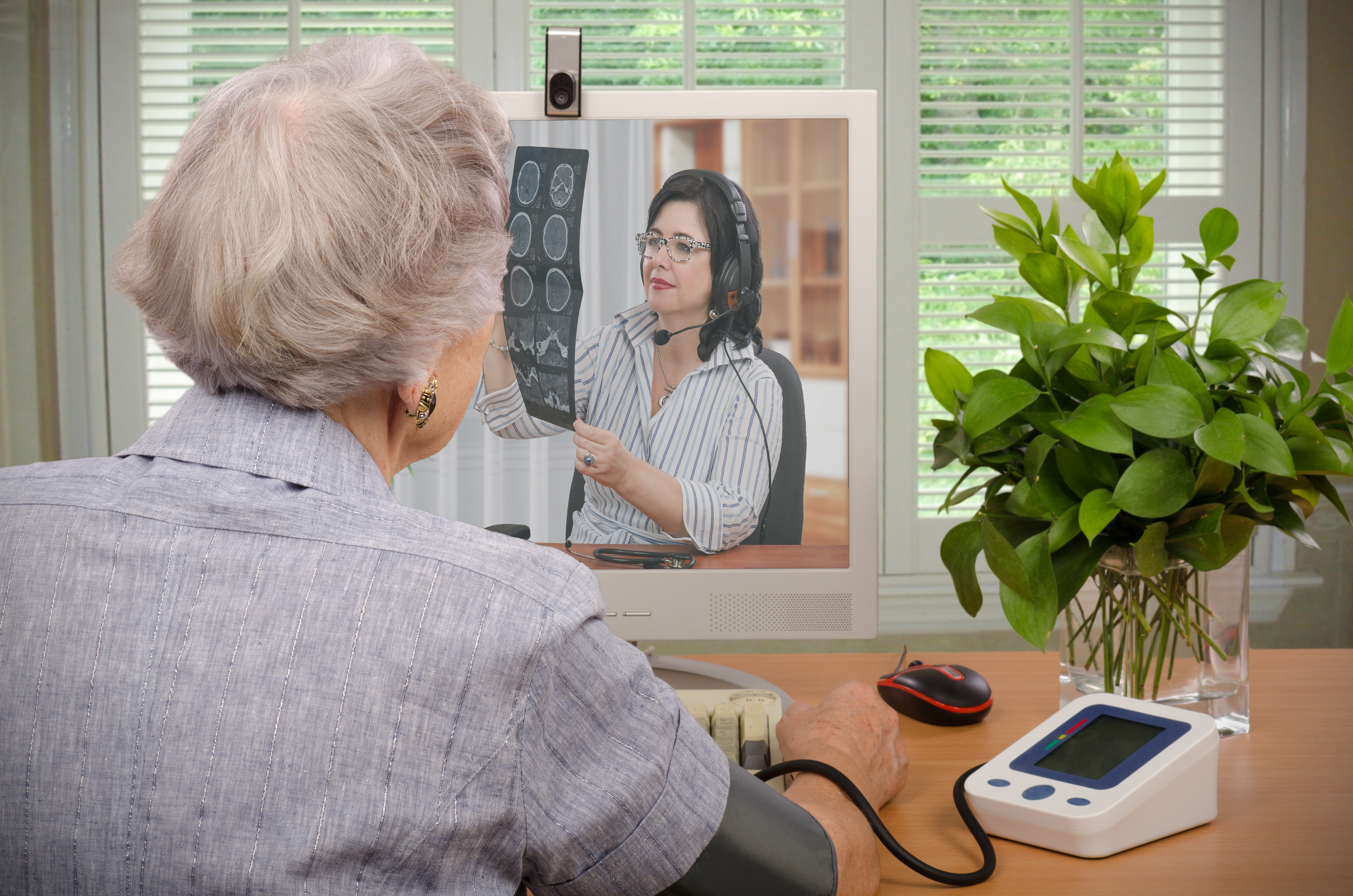 An older woman speaks to a medical professional via video chat