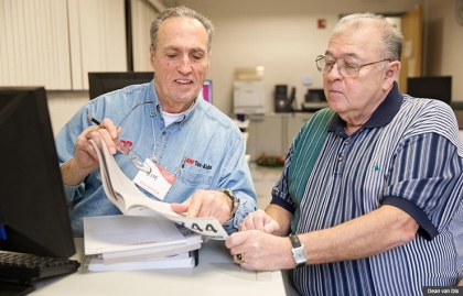Jim Gonzales, left, an AARP Foundation Tax-Aide volunteer, recommended the free tax-preparation service to Ray Jimenez, of Taylor