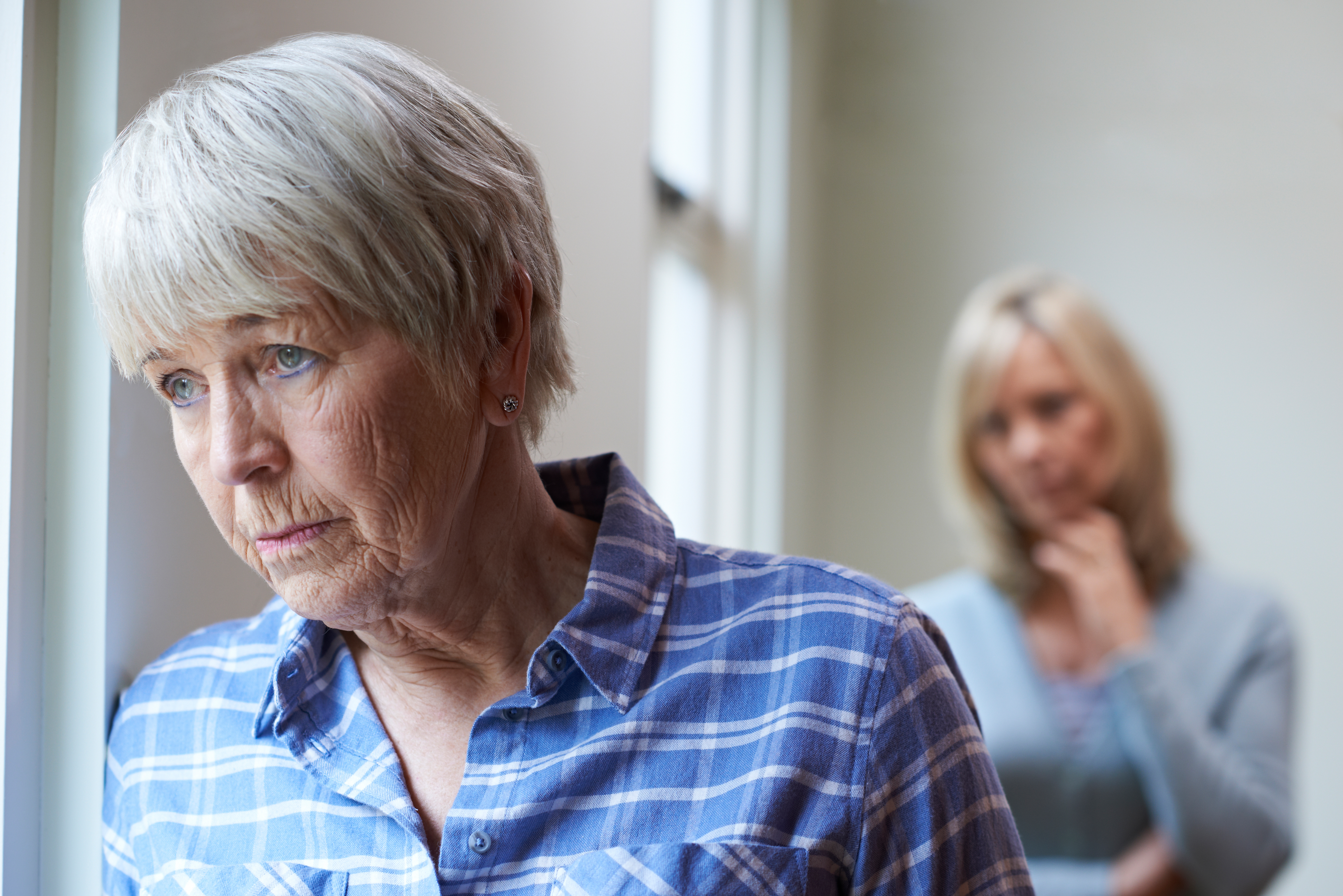 Serious Senior Woman With Adult Daughter At Home