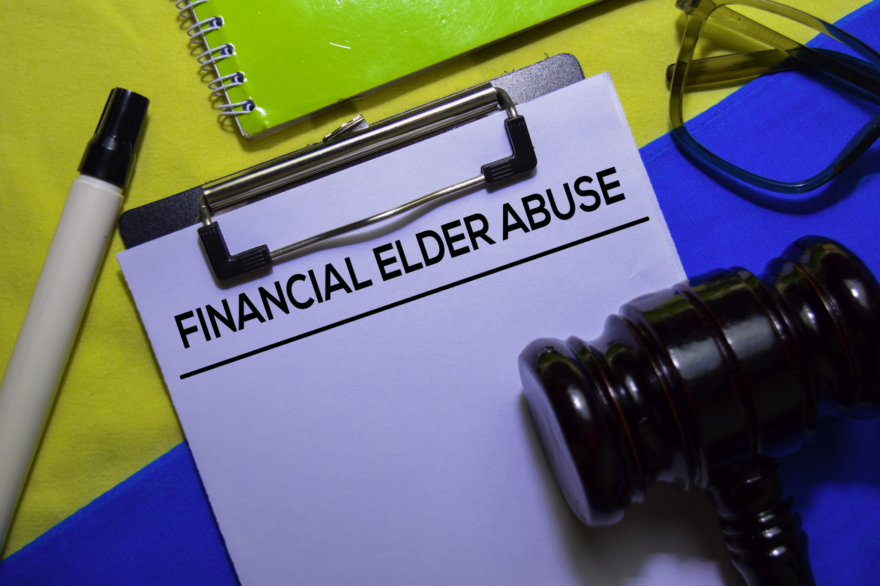 Financial Elder Abuse text on Document form and Gavel isolated on office desk.