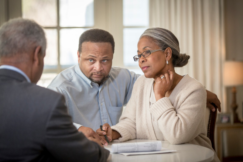 African American couple talking to man