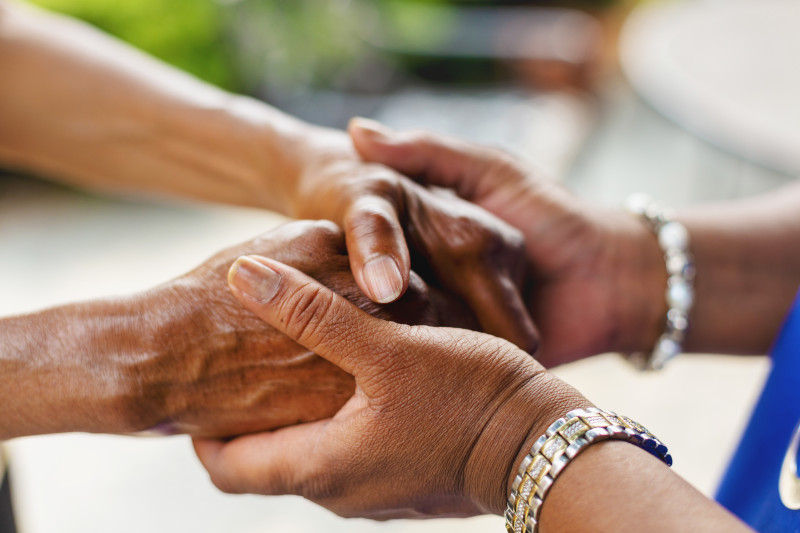 Two Mature Adult Women Holding Hands