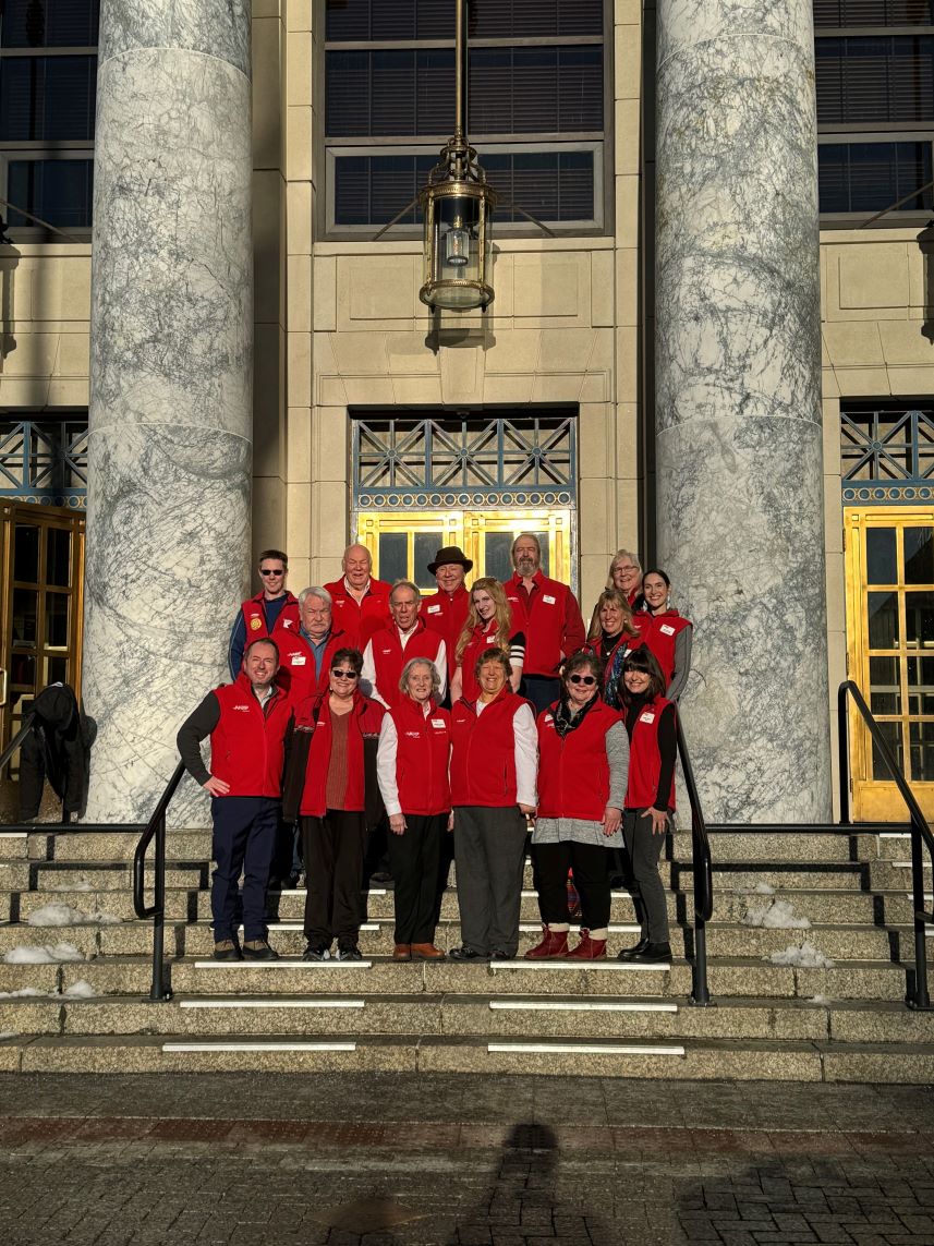 Photo of AARP Alaska advocacy volunteers and staff in front of the state capitol building in Juneau.